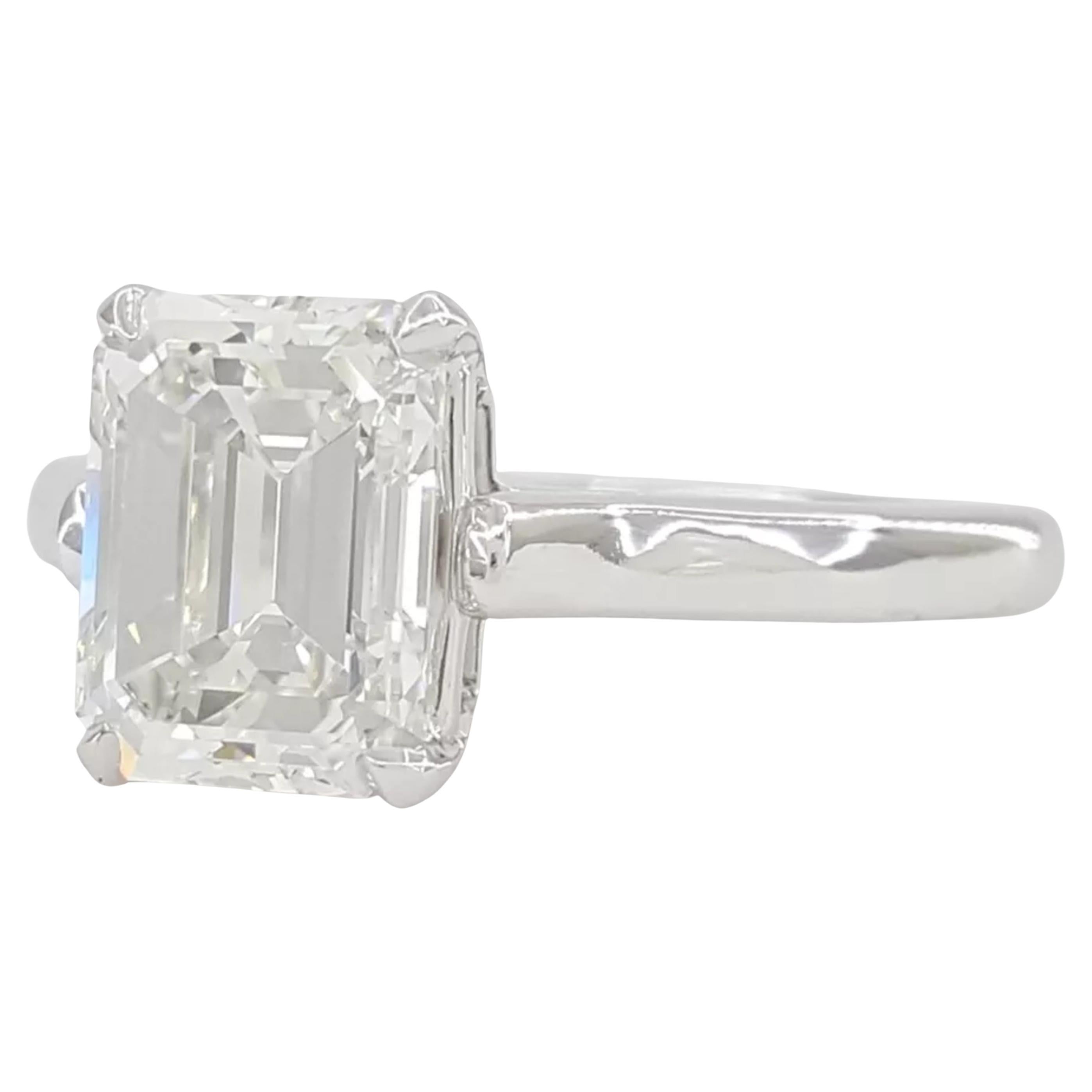 This exquisite engagement ring showcases a 3.01 carat emerald-cut diamond, certified by GIA for it's remarkable quality. Crafted in 18K white gold, the solitaire design highlights the timeless elegance of the center stone. 

The diamond's color