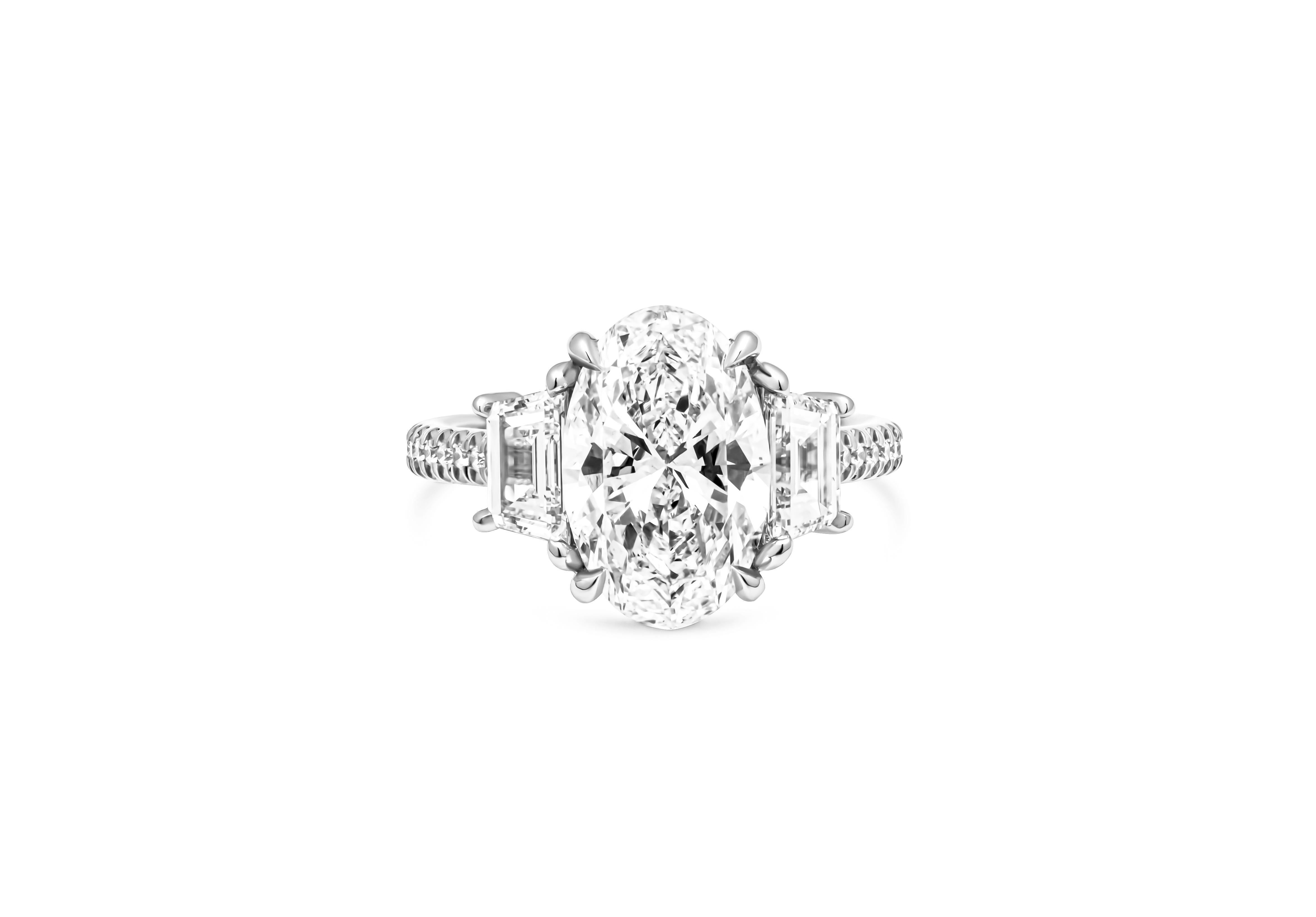 Introducing a breathtaking three-stone ring that effortlessly combines timeless elegance with contemporary sophistication. This exquisite piece features a mesmerizing 3.01-carat oval-cut diamond, certified by the Gemological Institute of America