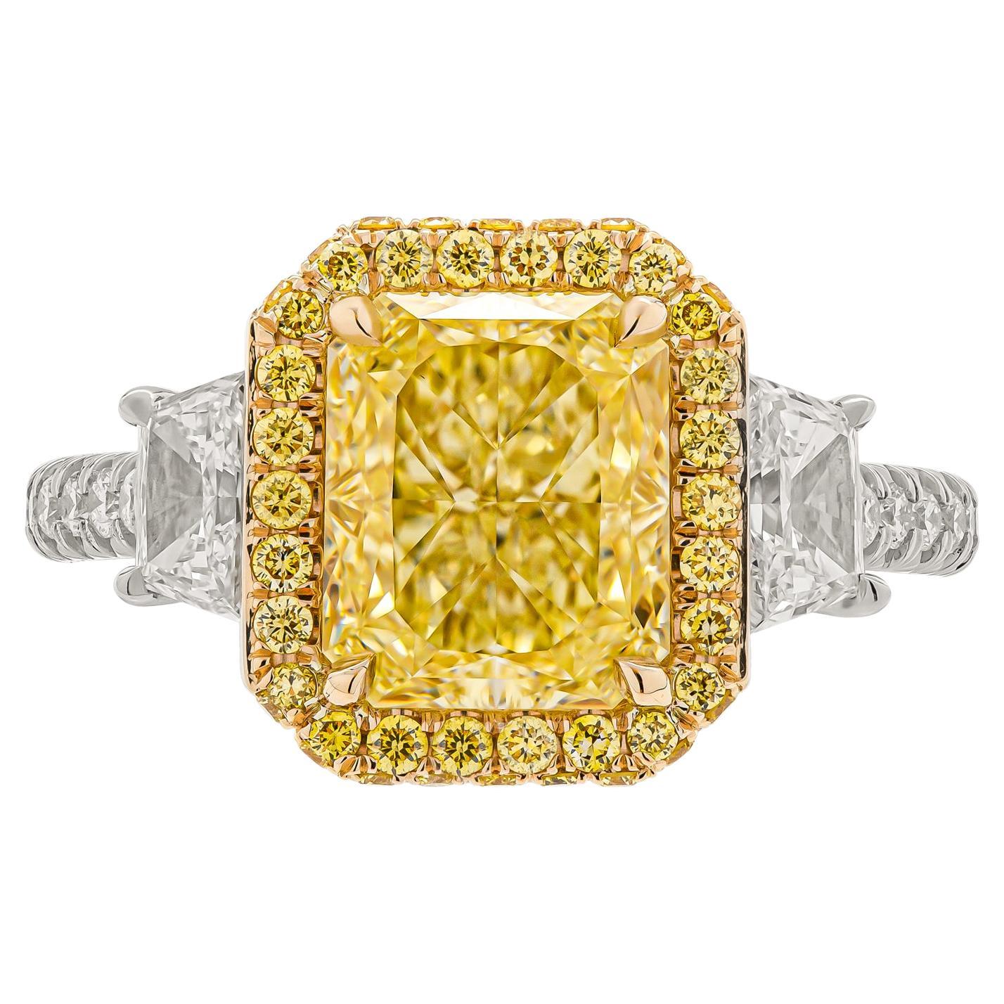 Engagement ring in 18K YG & PT950 Radian cut Diamond 3.04ct Natural Fancy Light Yellow Even VS2 
Center Stone: Radiant Shape Diamond GIA# 7406066295 3.04ct Natural Fancy Light Yellow Even VS2 Radiant 
Side stones: 0.61ct F VS Trapezoids 
Cathedral