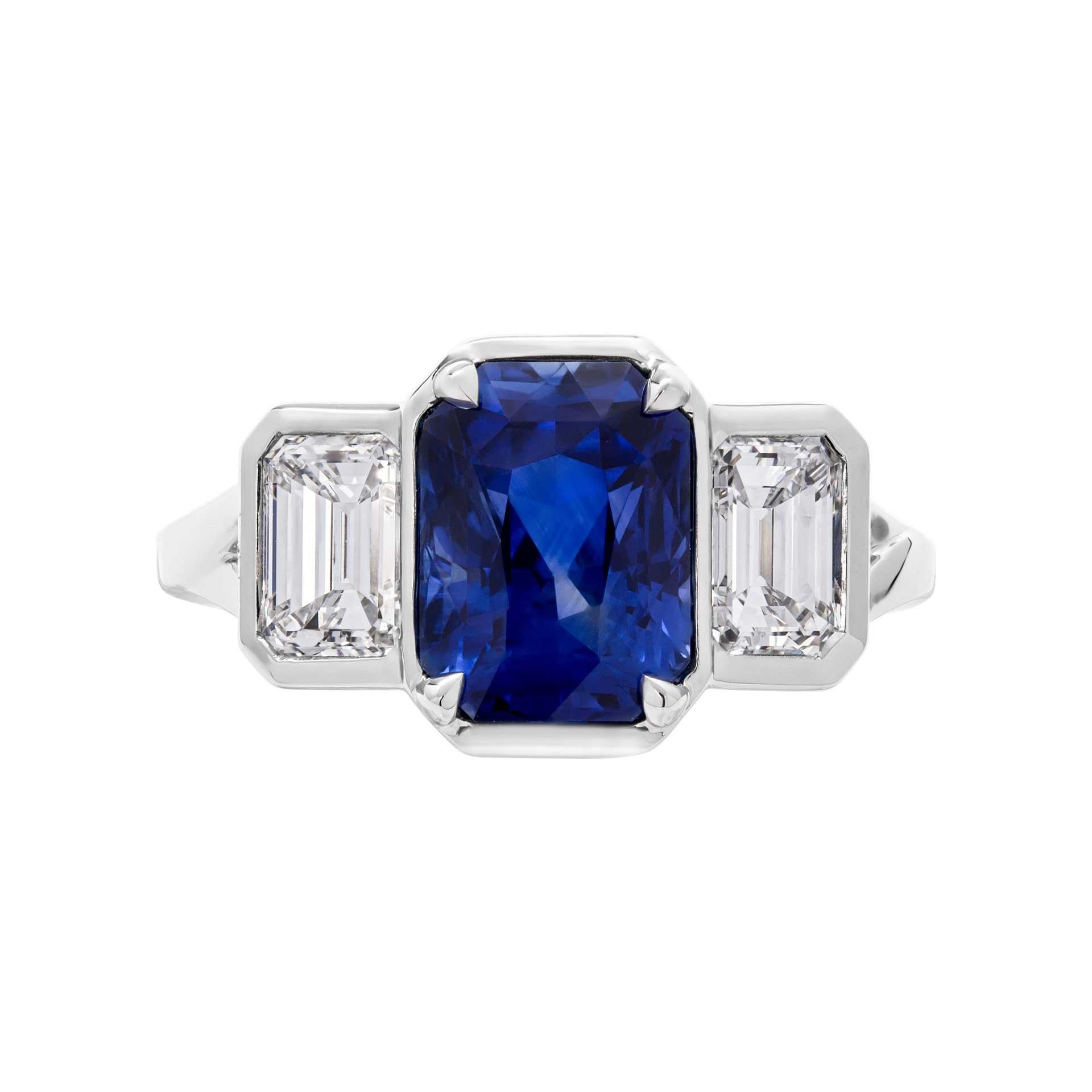 Inspired by modern influence and graphic lines , this Sapphire 3 stone ring will steal your heard with it`s beauty!
Delicate, yet bold mounted in Platinum with 3.31ct Radiant Shape Sapphire  and side stones emerald cut diamonds totaling 1.25ct G-H