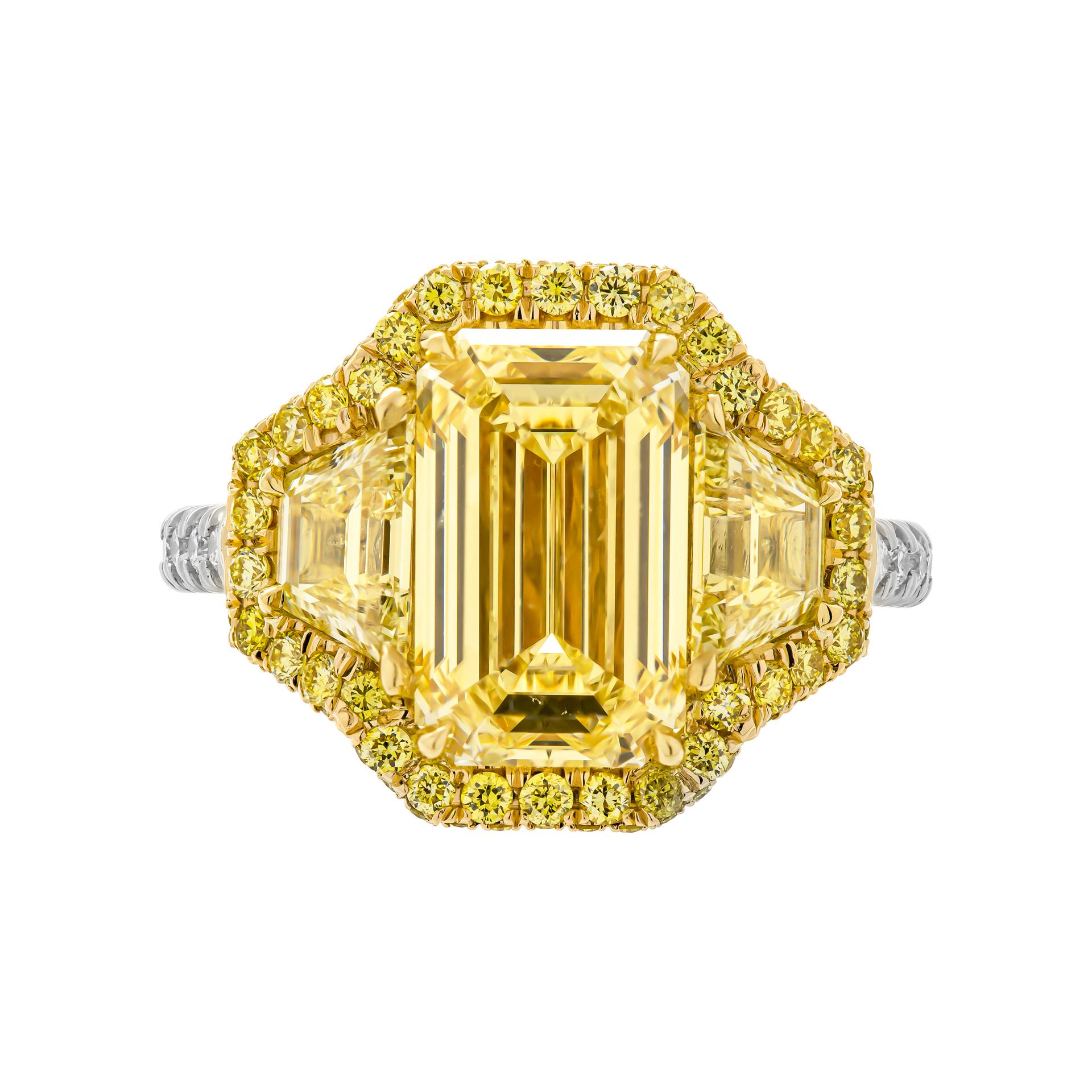 3 stone ring in Platinum & 18K Yellow Gold 
Center stone: 3.53ct W to X Range VVS1 Emerald Shape Diamond GIA#2215965991 
Side stones: 1.01ct Fancy Yellow VS trapezoids
Total carat weight of yellow pave: 0.65ct 
Total carat weight of white pave:
