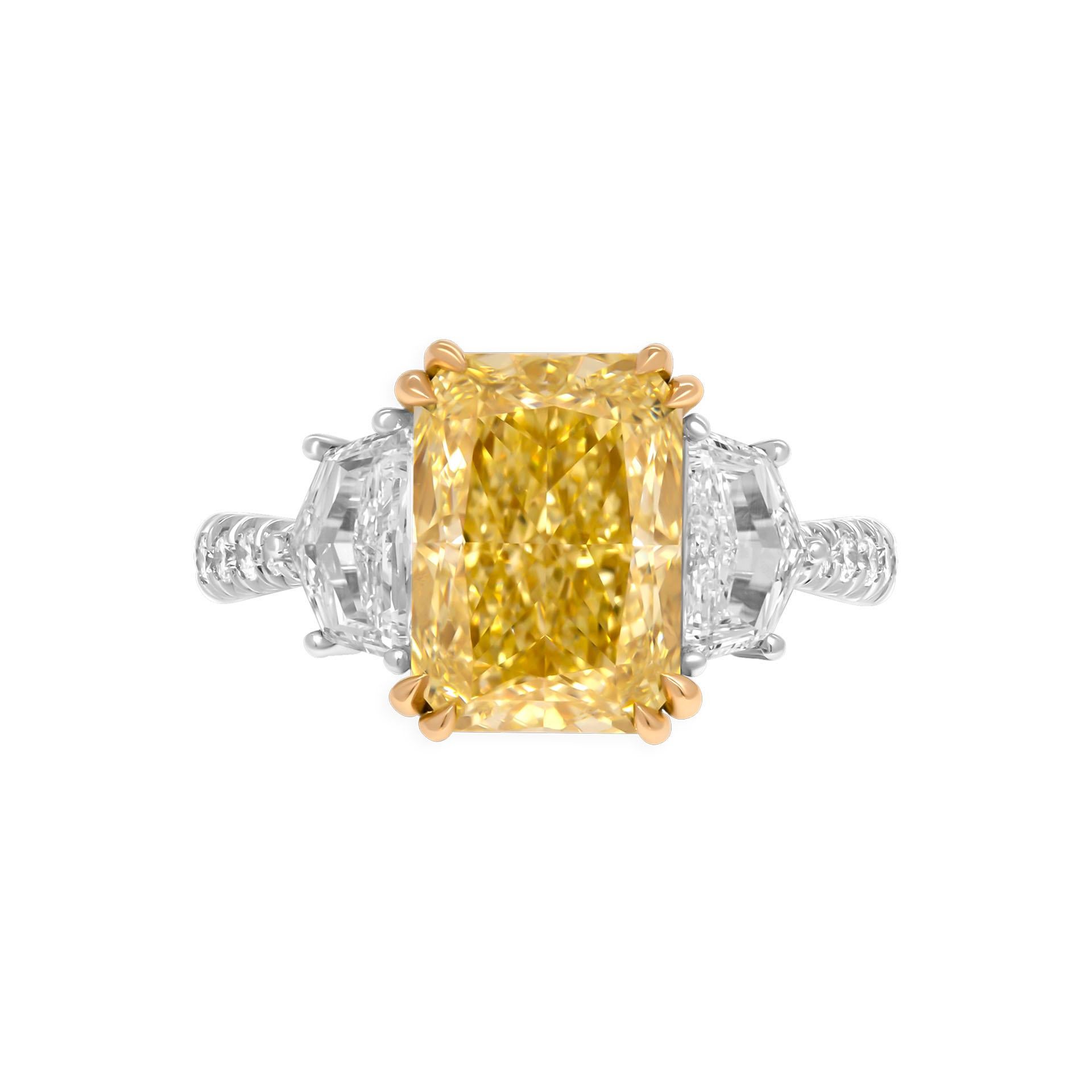 3 stone ring in Platinum & 18K Yellow Gold

Center stone: 4.02ct Natural Fancy Yellow Even VVS2 Radiant Shape Diamond GIA#2457008603 

Two side stones: 
0.50ct D VS1 Cadillac shape GIA#1413796012
0.40ct D VVS1 Cadillac shape