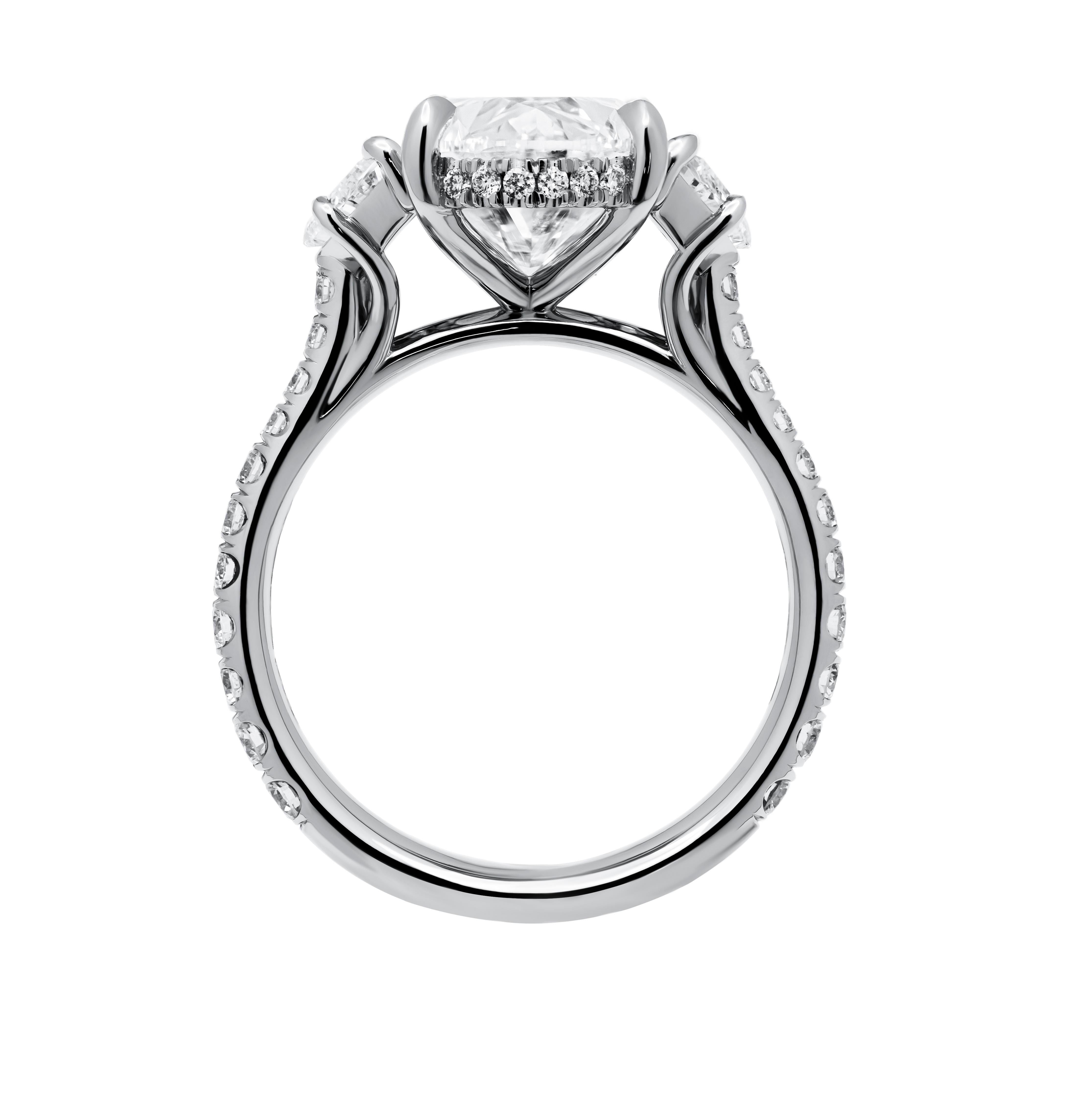 Elevate your style with this stunning three-stone ring, crafted in luxurious platinum to epitomize sophistication and grace. At its core gleams a breathtaking 5.03-carat oval-shaped diamond, boasting a captivating G color and alluring SI2 clarity,