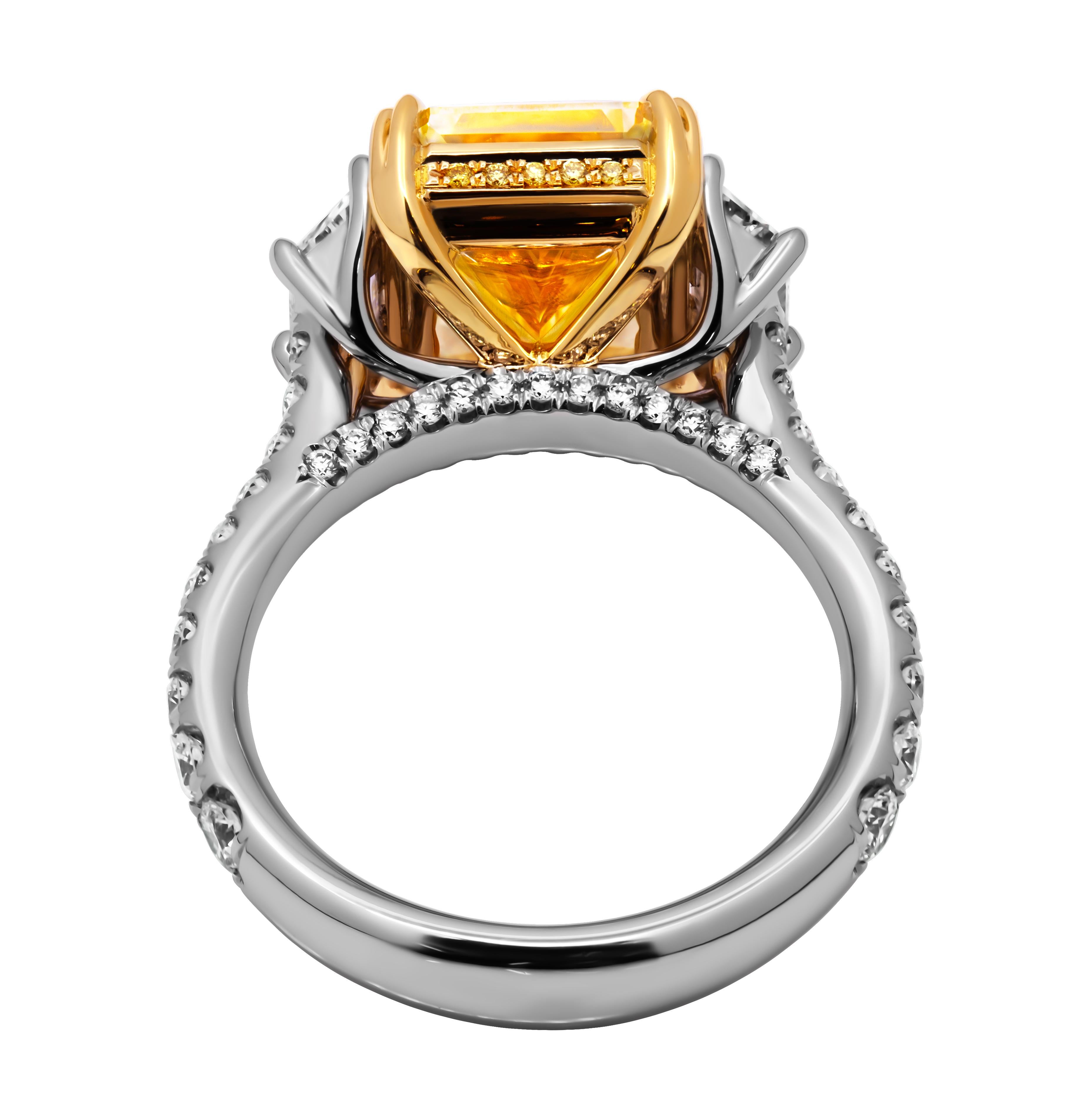 3 stone ring in 18k Yellow Gold & Platinum 
Diamonds on the shank, bridge and wrap under all 3 stones 
Center stone is 6.01ct Natural Fancy Yellow Even VVS1 GIA#3465640195 Radiant 
Two side stones: 0.40ct G VS1 GIA#7486235643 Trapezoid 
            
