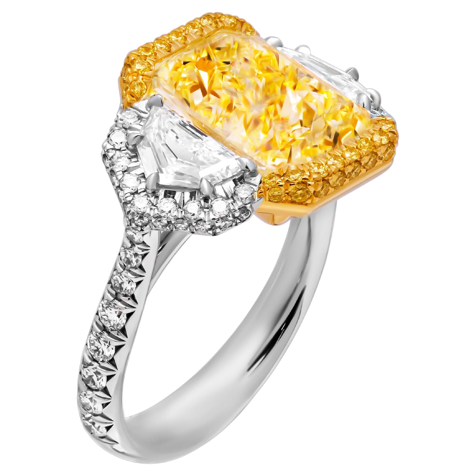 GIA Certified 3 stone ring with 7.06ct Fancy Light Yellow Radiant Cut Diamond For Sale