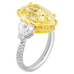 GIA Certified 3 Stone ring with 7.78ct Fancy Yellow Pear Shape Diamond