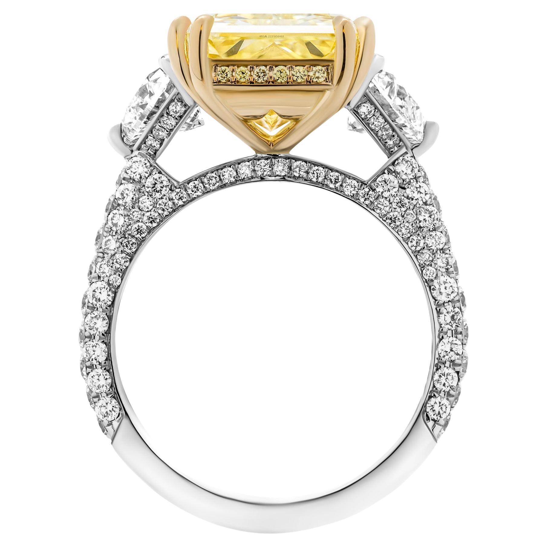GIA Certified 3 stone ring in 18K Yellow Gold & Platinum 

Center stone: 5.38ct Natural Fancy Yellow VS1 Radiant GIA#7463281247 
Two side stones: 0.31ct D IF GIA#1433628992 trapezoid 
                             shape diamond 
                     