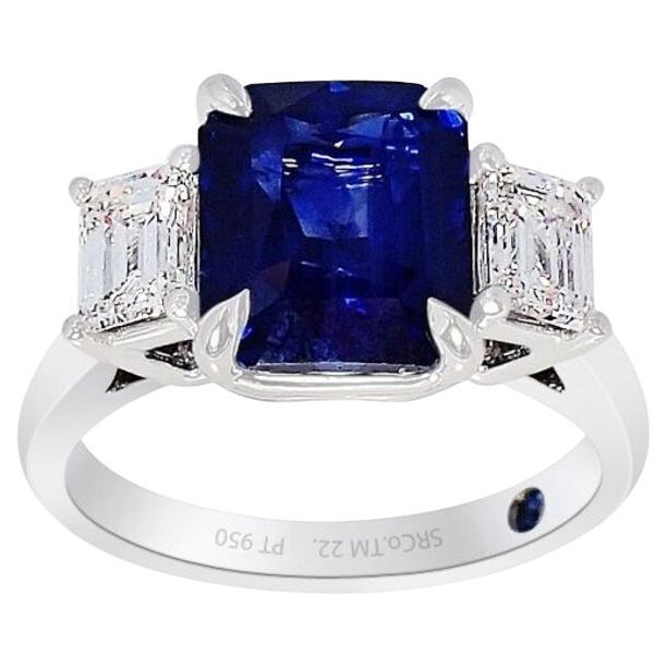 New platinum sapphire ring containing a square cut natural blue sapphire from Madagascar measuring 9.20 x 7.88 x 6.07 mm and weighing 4.22 carat. Type II. Medium dark, strong, blue color GIA B 6/5, set with 2 emerald cut diamonds, a weight 0.40 ct