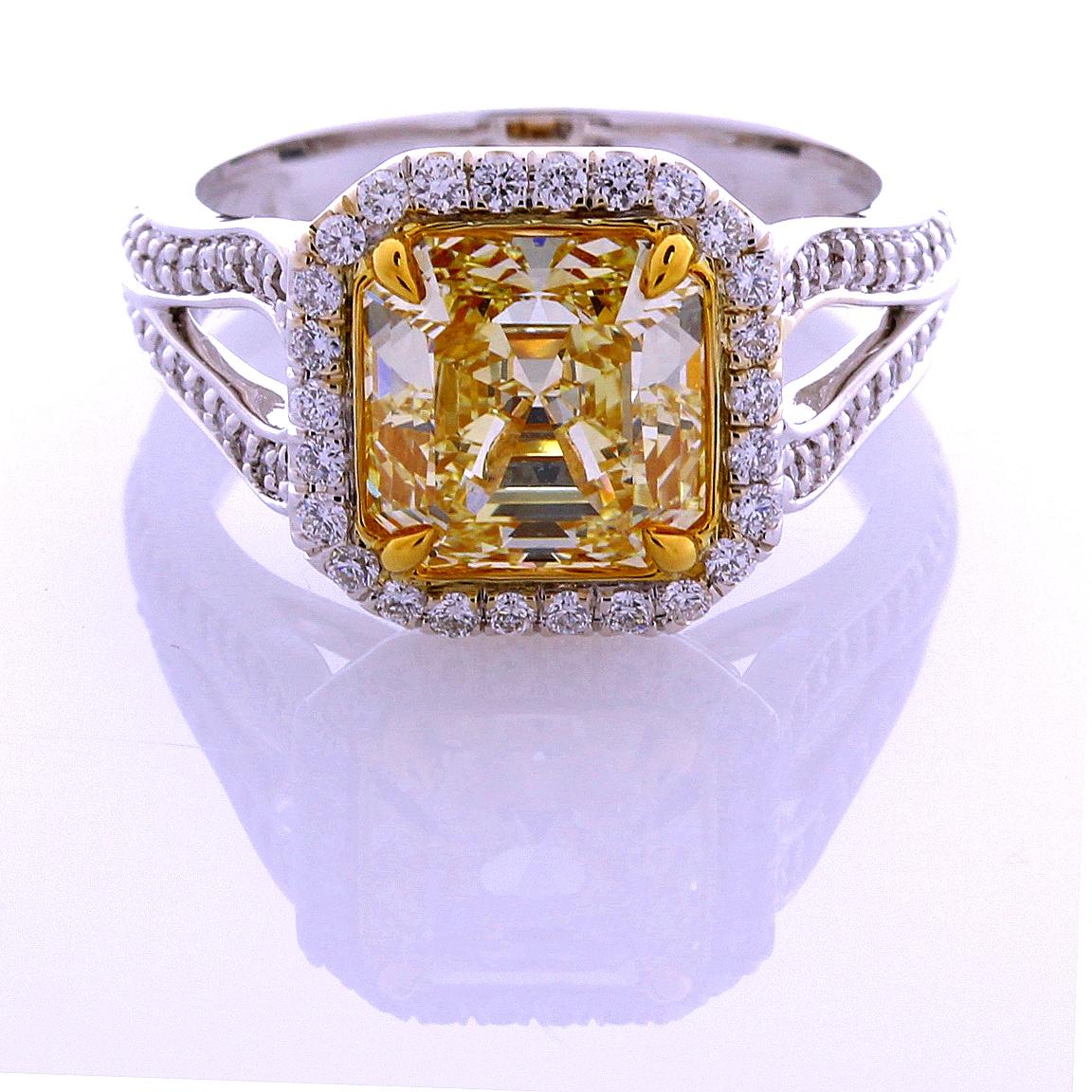 Incredible Deal on GIA Certified 3.00 Carat Asscher Cut, Natural Fancy Yellow Even Diamond Ring, VVS2 clarity, measuring 8.09-7.96x5.39. Total Carat Weight on the ring is 3.53.
GIA CERTIFICATE #16824998. 
This Unique mounting was custom made by Leo