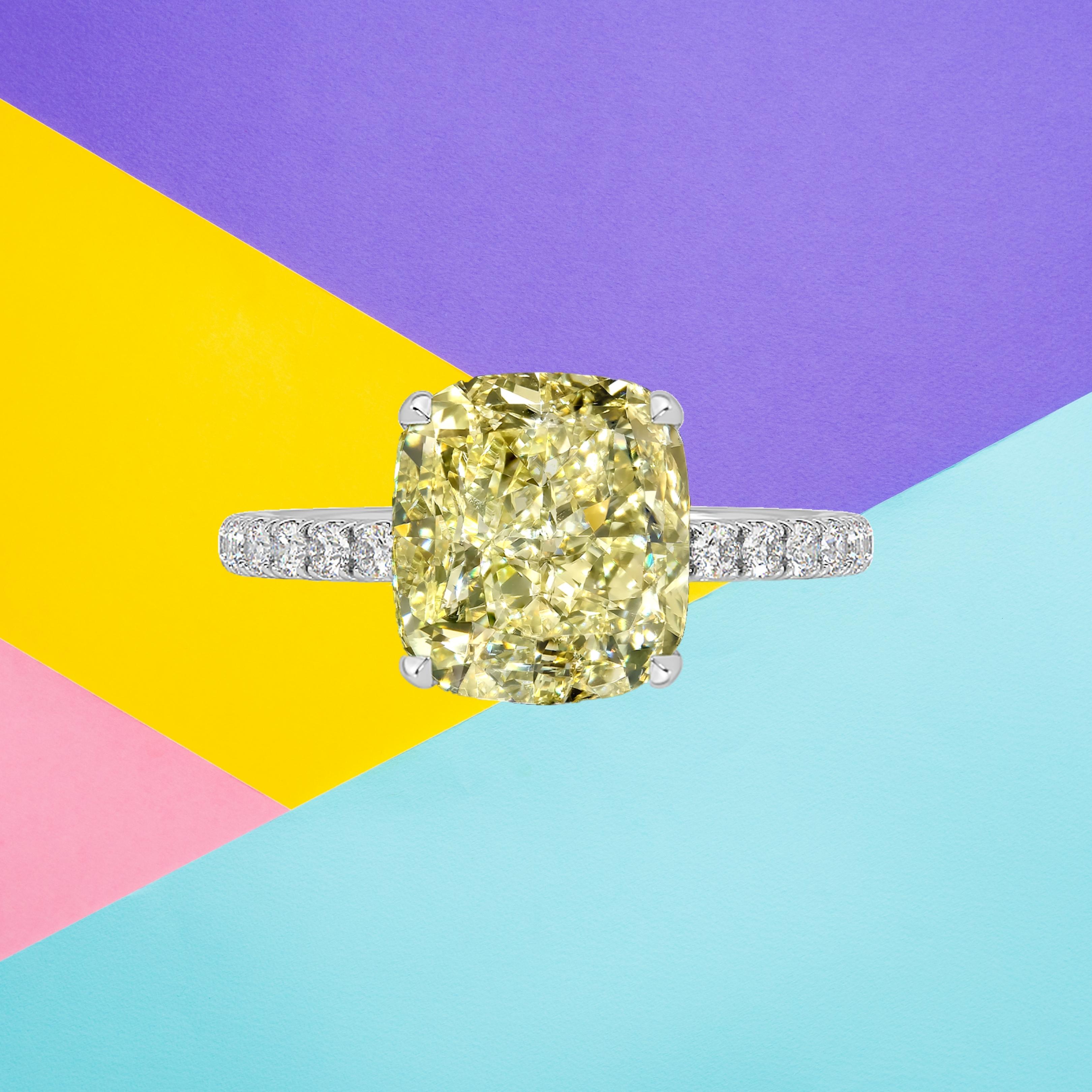 This cushion cut diamond weighs 3.00 carat and is certified 'Fancy Yellow' color by the Gemological Institute of America. The GIA has also assigned a VVS1 grading to the stone. The diamond has been inscribed with the certificate number to guarantee