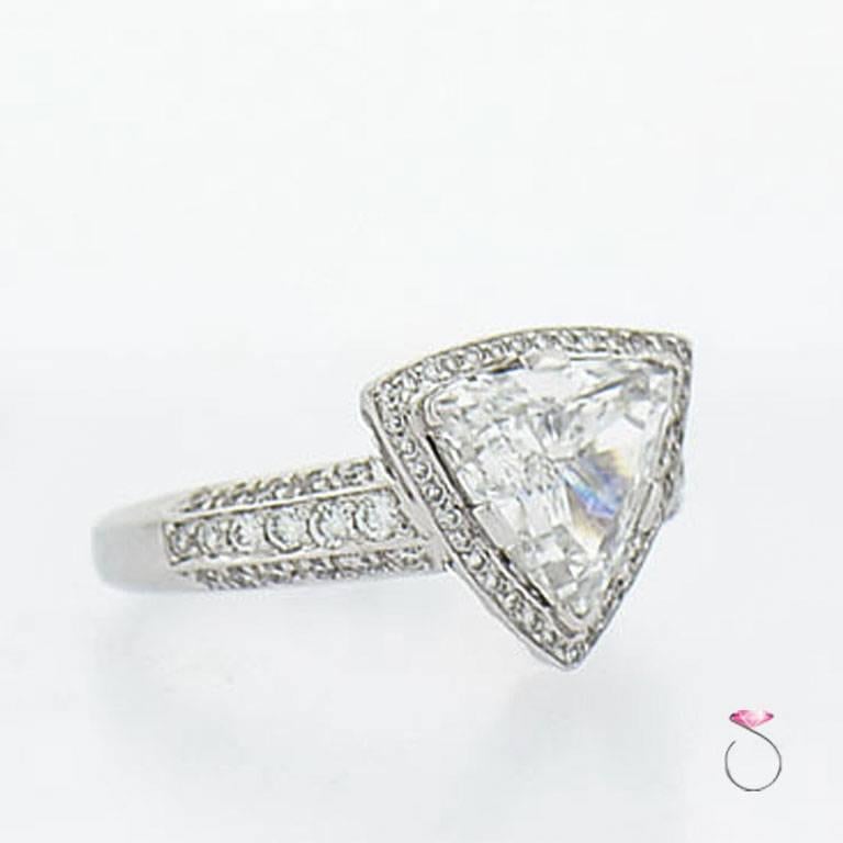Platinum Diamond halo ring with a beautiful GIA certified 3.00 ct. Trilliant cut diamond, E color, VS1 clarity. The center diamond is surrounded by a triangle shaped diamond halo. The ring's shank is set with three rows of round brilliant diamonds