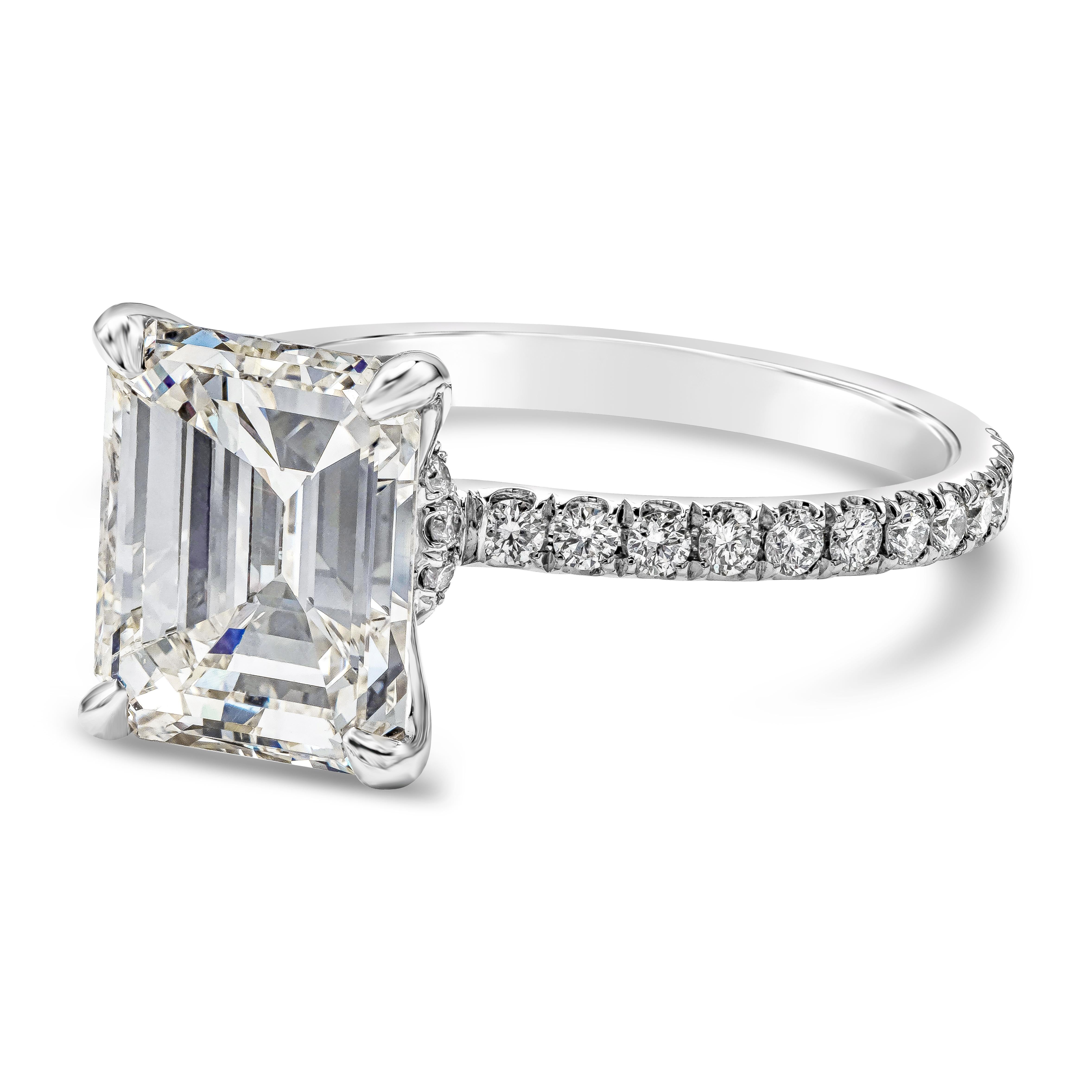Showcasing a 3.00 carats emerald cut diamond certified by GIA as I color, SI1 in clarity, set in a polished platinum four prong setting and accented with brilliant round diamonds. Accent diamonds weigh 0.40 carats total. Size 6 US resizable upon
