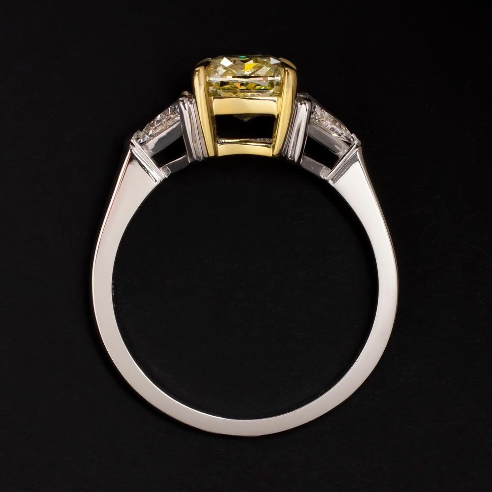 Amazing GIA Certified natural 2.31 carat fancy yellow si1 clarity cushion cut diamond ring with two side trillion natural diamonds at each side mounted in 18 carats yellow gold and platinum.

Inquire us about the cost of the main stone without the