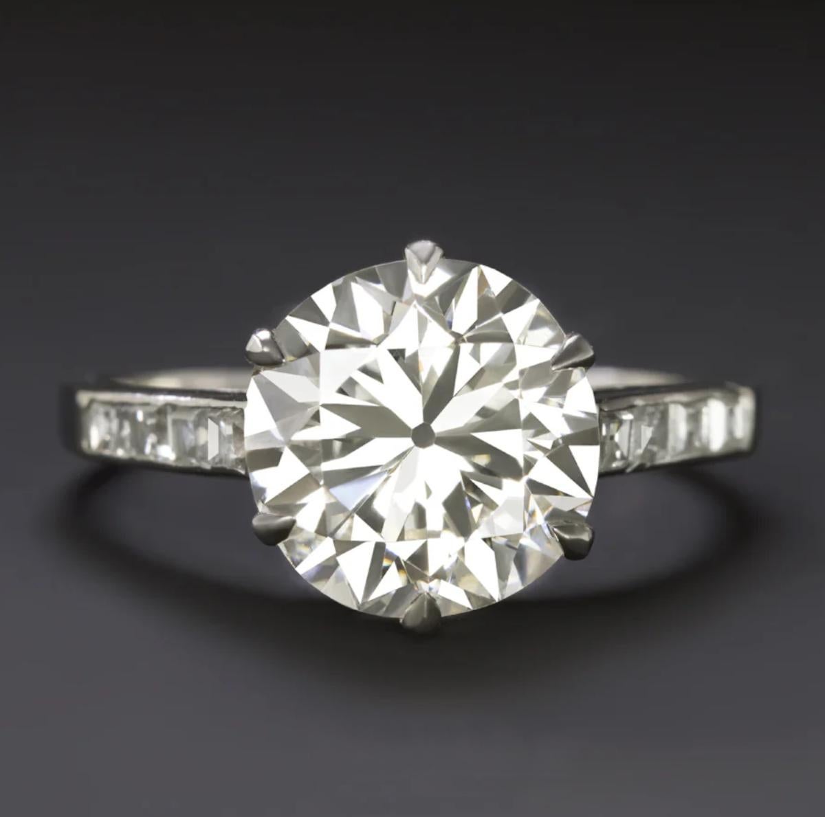 A true statement of timeless elegance, this vintage engagement ring features an impressive 3.00 carat old transitional cut diamond at its center. GIA certified and graded K color (faint brown) with exceptional VS1 clarity, the diamond is beautifully
