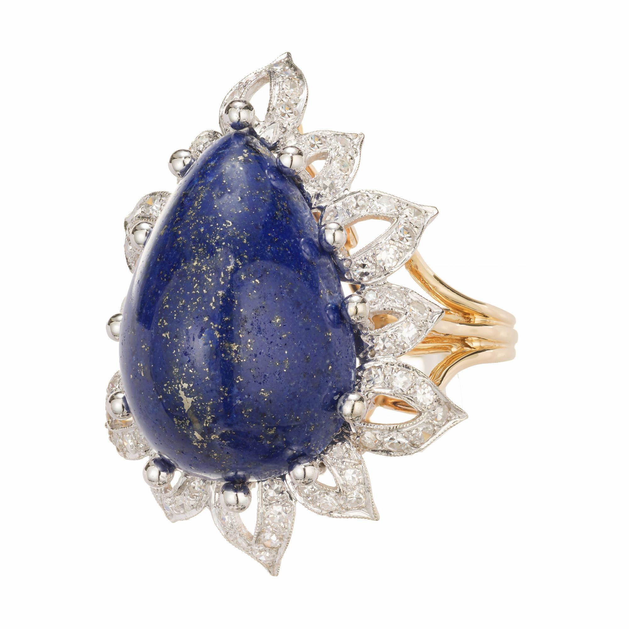 Bright blue natural 30.00 carat untreated lapis lazuli cocktail ring circa 1955-1965 in a flower type design with yellow and white gold  with diamonds

1 pear shape violetish blue cabochon lapis lazulli, approx. 30.00cts GIA Certificate #