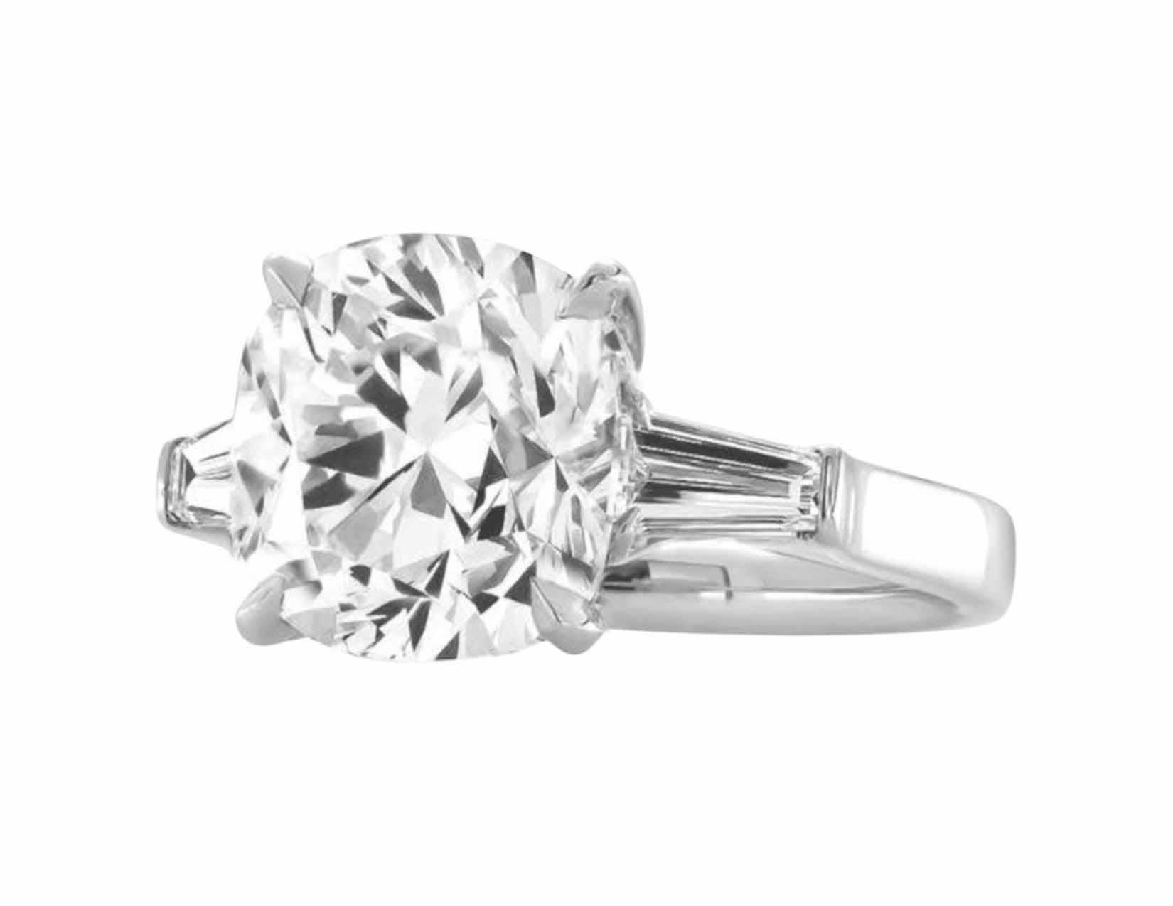 This exquisite ring features a 3.01 carat cushion brilliant cut diamond as its dazzling centerpiece, accented by two tapered baguette diamonds. 

The central diamond boasts F color, near colorless and exhibiting exceptional brilliance, with only