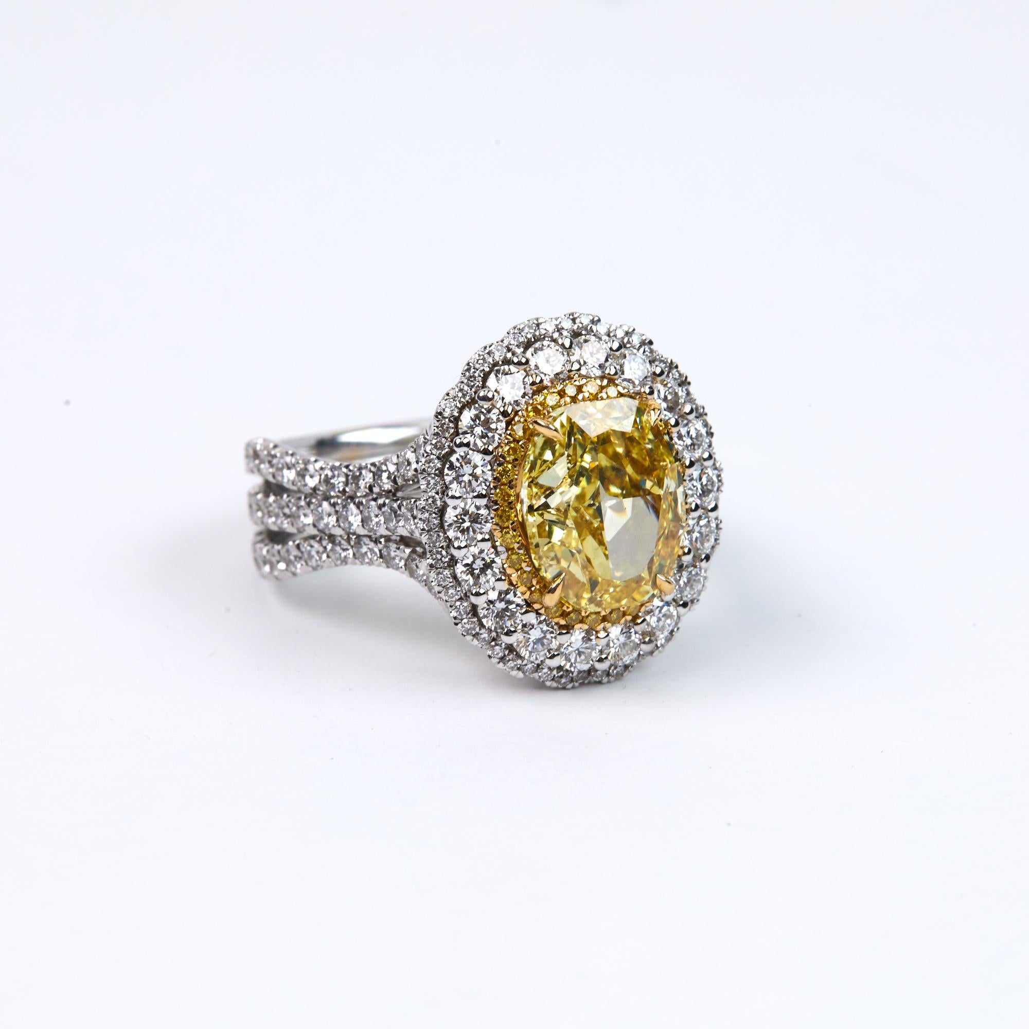 GIA certified, Fancy Intense Yellow Brilliant Oval Cut Diamond, weighing 3.01 carats.  This one of a kind ring can be worn as an engagement ring or as a fashion ring.  GIA certified and Lazar inscribed, please request the GIA certificate.  Another