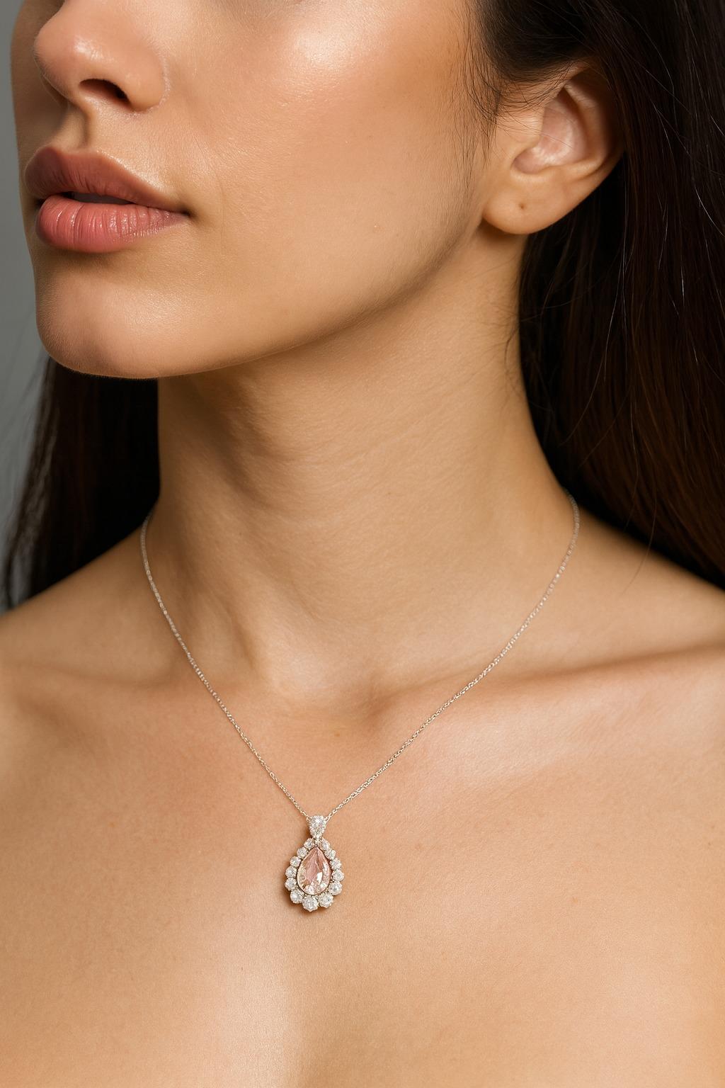 GIA Certified 3.01 Carat Fancy Light Orangy Pink Diamond Platinum and Gold Pendant Necklace

A rare and feminine diamond pendant showcasing a certified Fancy Light Orangy Pink pear-shaped diamond, accented with white and pink diamonds in a