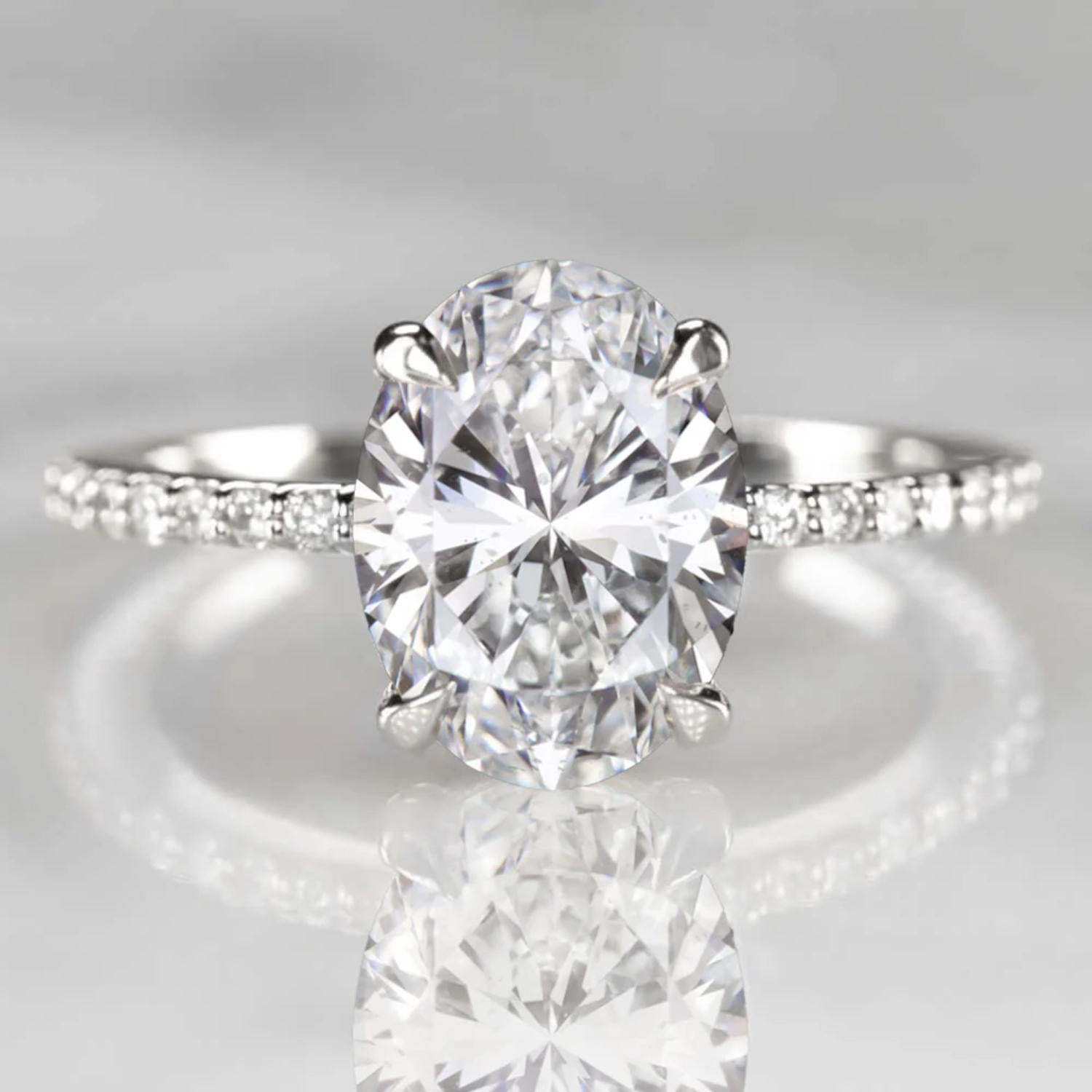 This breathtaking engagement ring showcases a magnificent 3.01 carat GIA certified oval cut diamond at its center, distinguished by a rare and coveted D color grade the highest on the scale signifying complete colorlessness and exceptional purity.