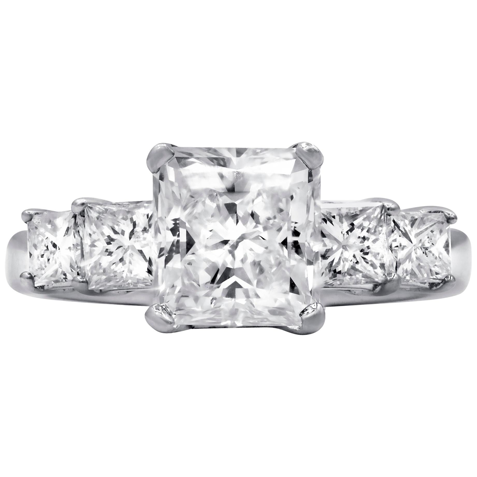 GIA certified 3.01 Carat Radiant cut Diamond Engagement Ring
Center stone: 2.01 G Color SI1 in clarity, GIA Certified Radiant 
Side diamonds: 1.00 carat total weight of 4 princess cut diamonds, each stone 0.25 carats.