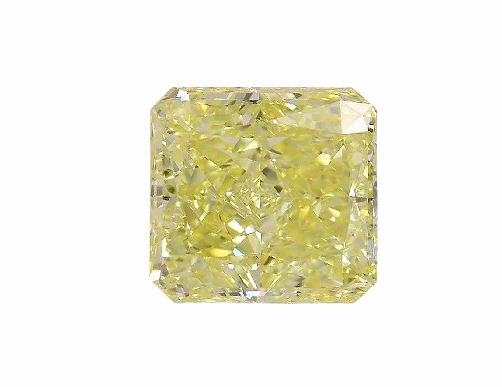 This magnificent engagement ring features a 3 carat radiant cut fancy intense yellow diamond, set in a stunning combination of 18K white gold and 18K yellow gold. 

The vibrant color of the central diamond exudes warmth and luxury, making it a