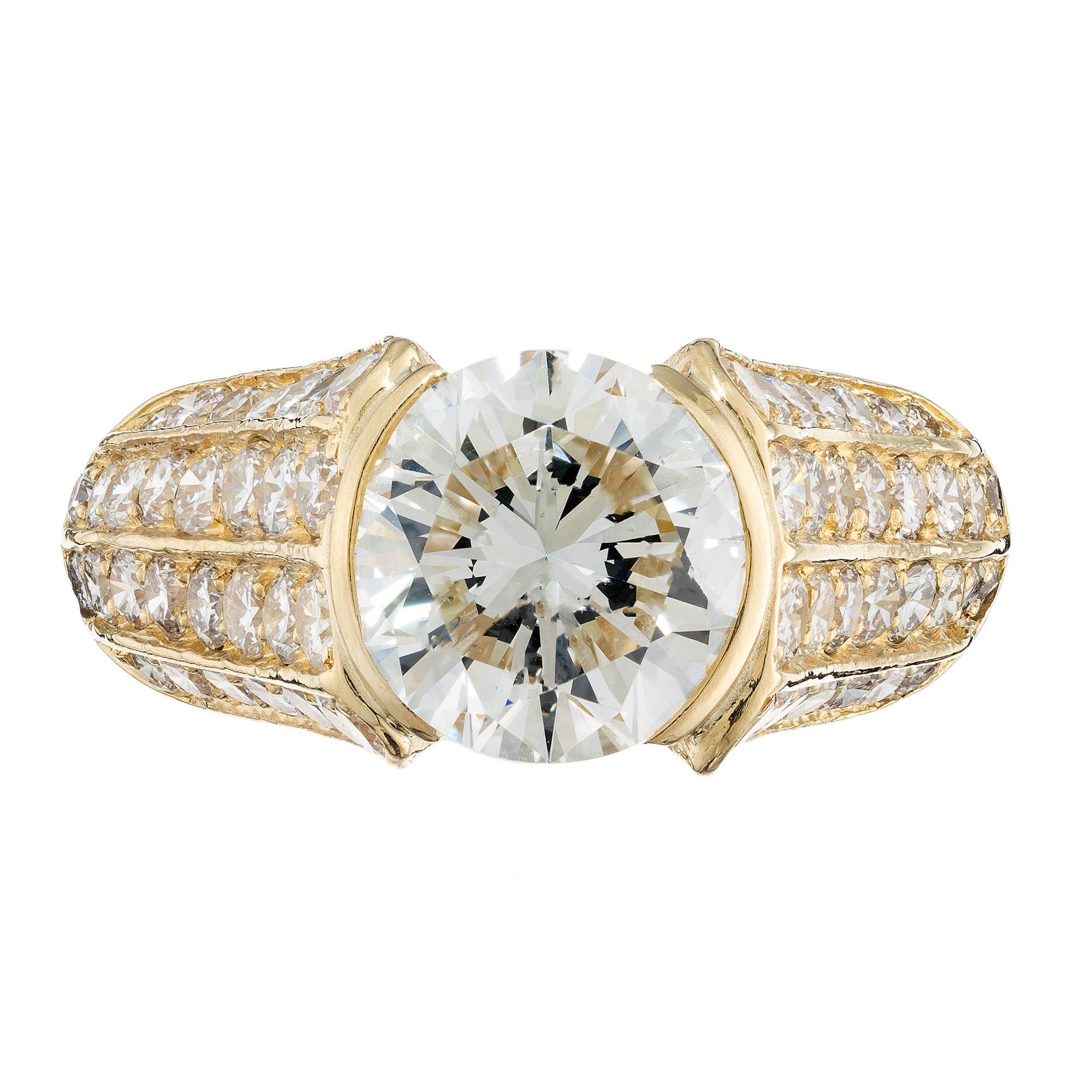 This 1970's stunning 18k yellow gold engagement ring features a magnificent GIA certified 3.01 carat round brilliant cut, semi bezel diamond center stone. The shoulders of this ring is set with 80 round full cut pave set diamonds totaling 2.21cts.