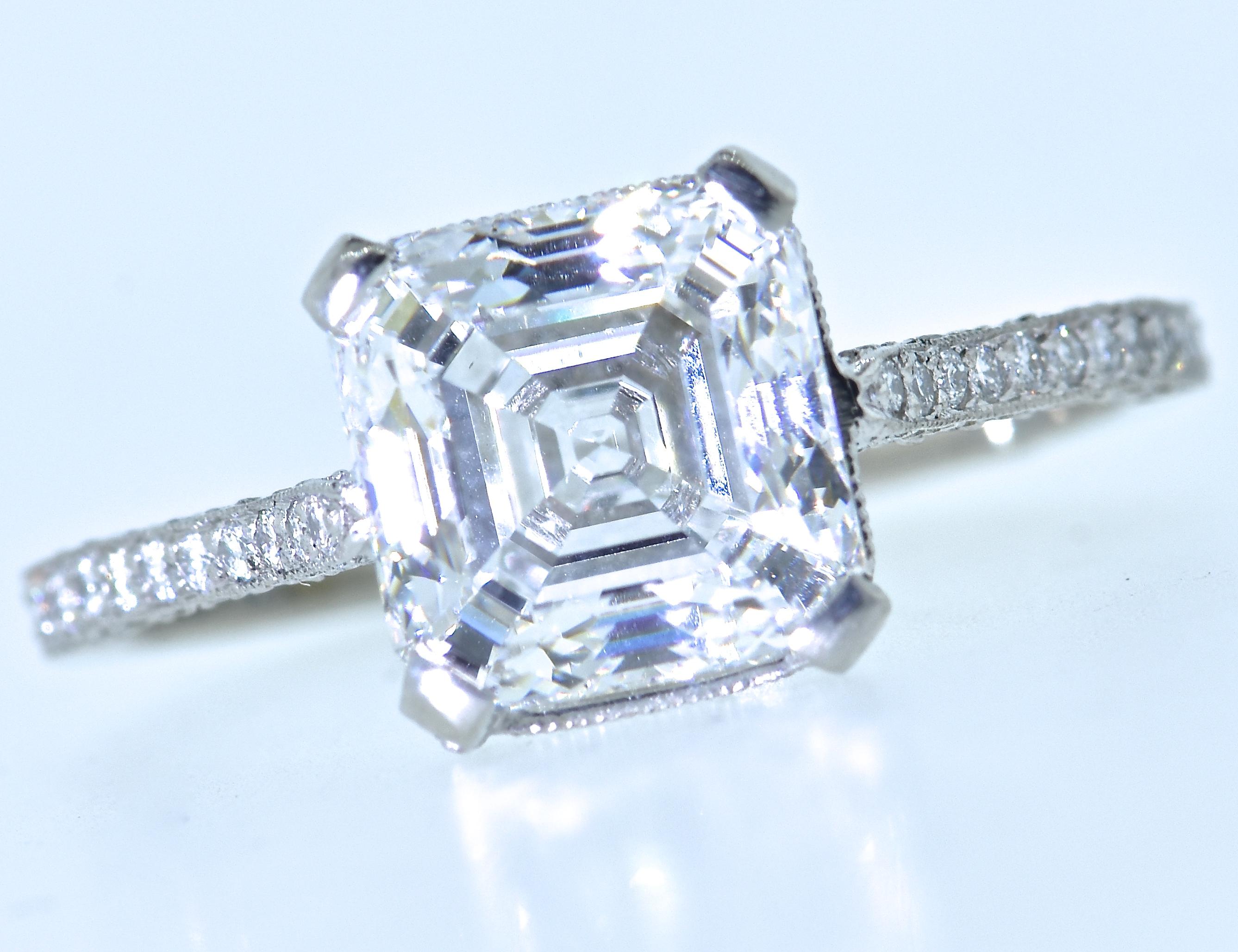 Pierre/Famille has hand made a fine micro pave platinum ring centering a  - recent -GIA graded Asscher cut diamond weighing 3.01 cts has been examined by the Gemological Institute of American and determined to be G in color (at the highest range of