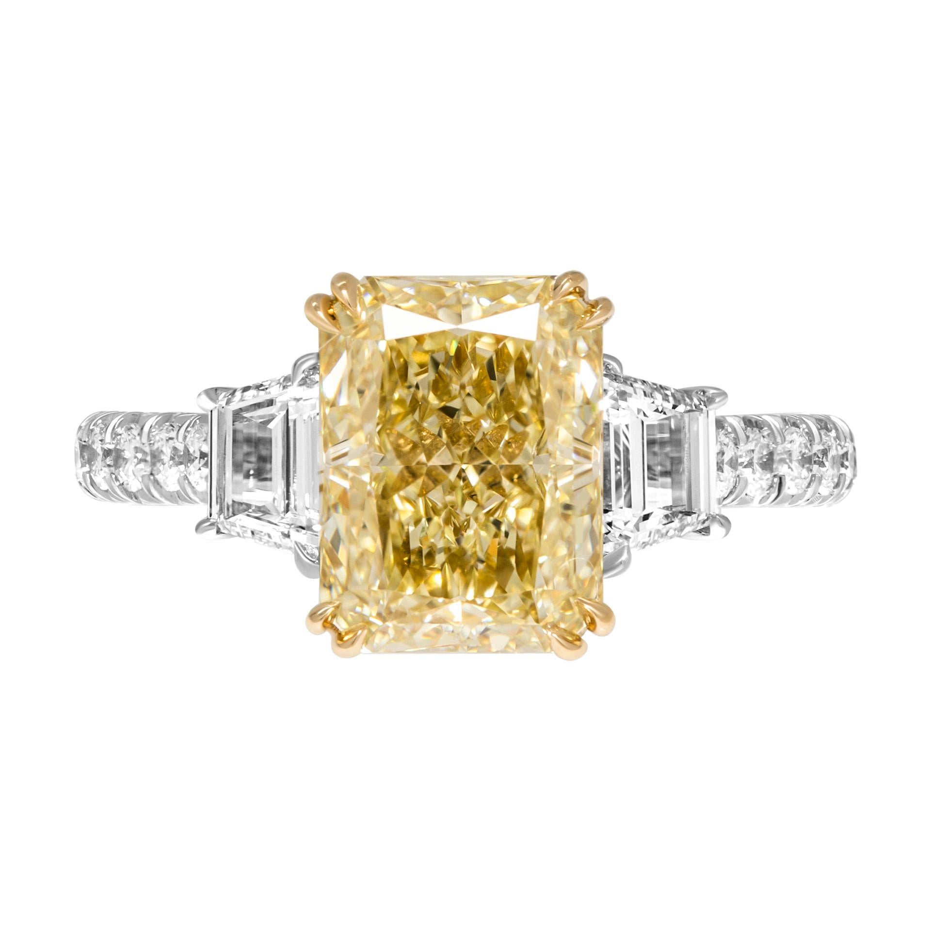 GIA Certified Three stone rings in 18k Yellow Gold & Platinum 
Diamond shank, double claw prongs on center stone, diamond wrap on center stone head
Center: 3.01ct Fancy Light Yellow Even VS2 Radiant Shape Diamond GIA#2225857282 
Two side stones: