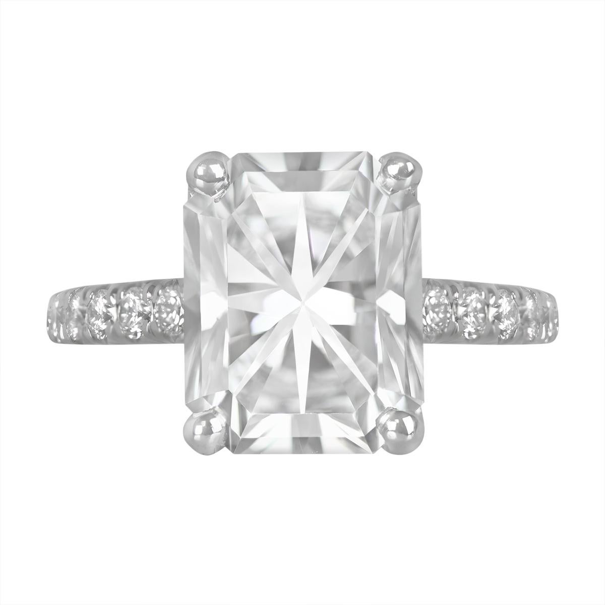Prepare to be dazzled by the sheer magnificence of this estate platinum and diamond ring. At its core shines a GIA-certified radiant cut diamond, boasting an impressive weight of 3.01 carats, with a brilliant F color and impeccable VS1 clarity. The