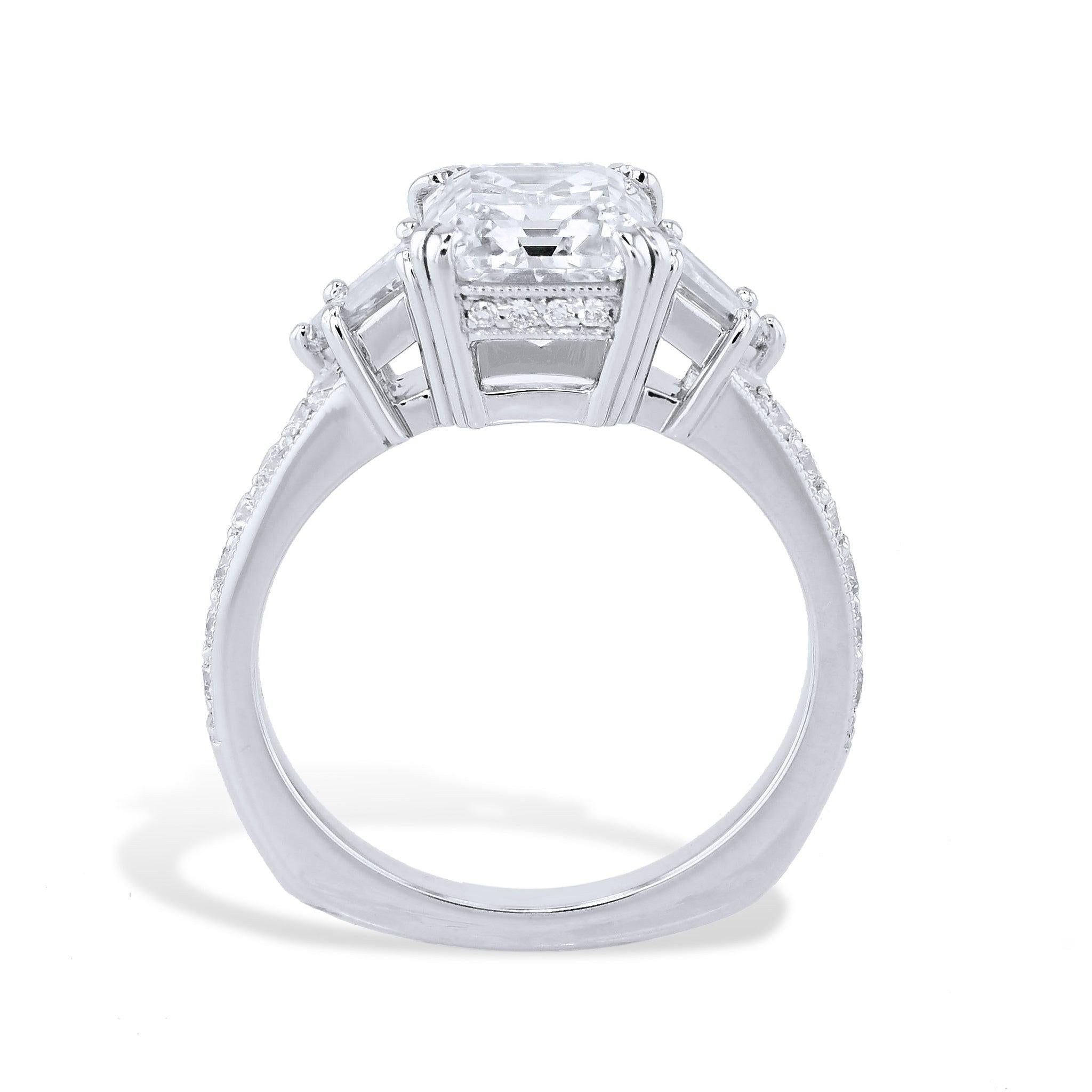 Emerald Cut Diamond Platinum Engagement Ring sets a new standard for luxury. 
Framed by 2 sparkling bullet cut baguette diamonds and 20 exquisite pave set diamonds, this masterpiece is further complemented by delightful pave diamonds that adorn the