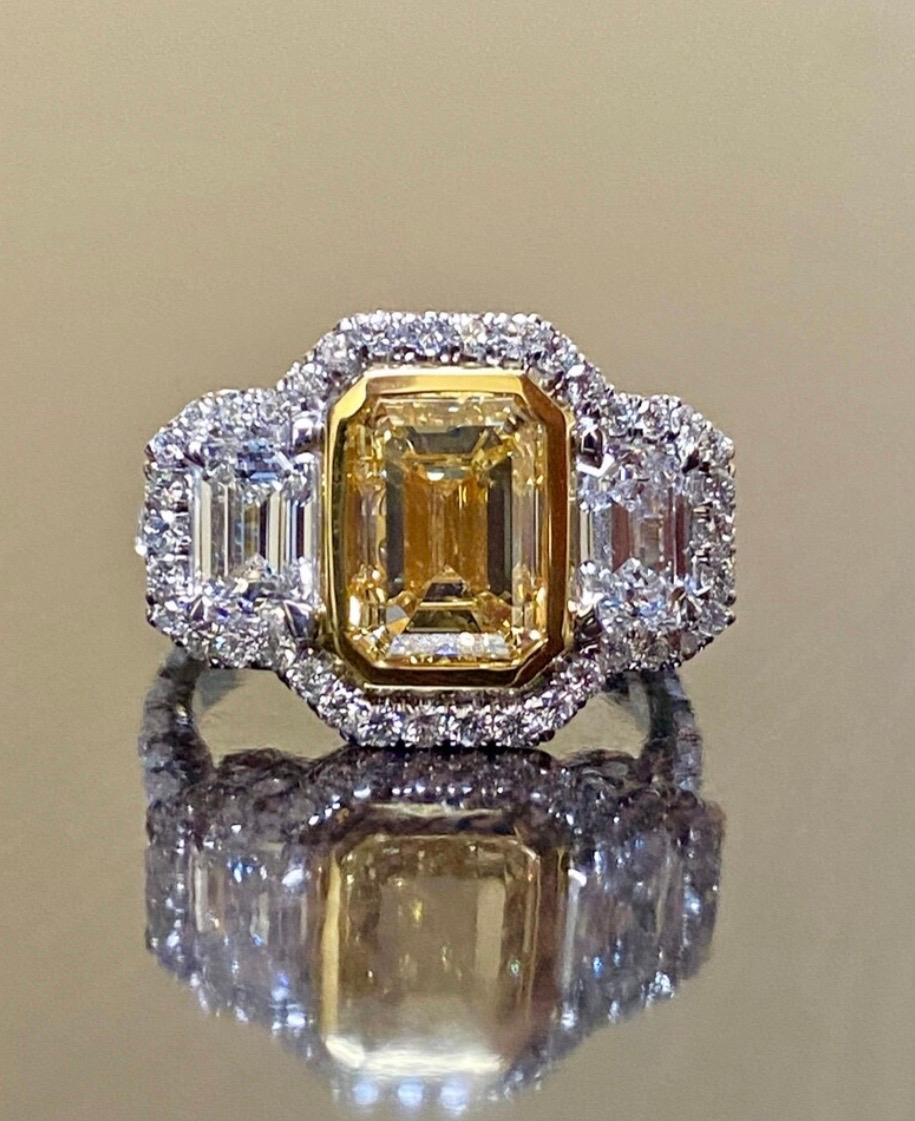 DeKara Design Collection

Metal- 18K White Gold, .750.

Stones- GIA Certified Fancy Yellow Emerald Cut Diamond 3.02 SI1 Clarity, 2 Emerald Cut Diamonds, 38 Round Diamonds F-G Color VS2-SI1 Clarity 1.58 Carats.

4.60 Total Carat Weight

Ring Comes