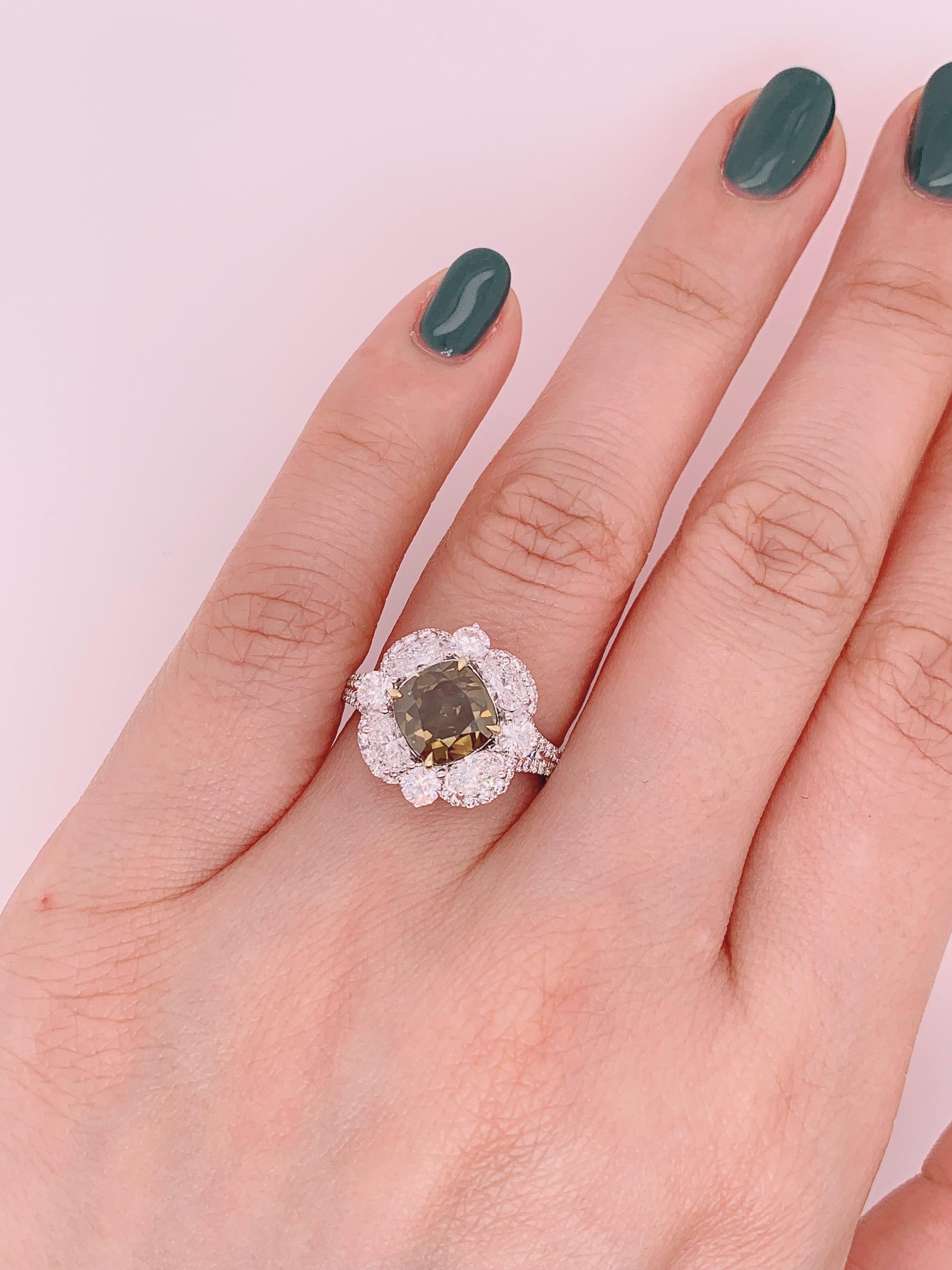 Featuring a 3.02 carat Fancy dark brown-greenish yellow Diamond Ring  , with white oval shape diamond. Finished in white gold. 

Center stone certified by worldwide known GIA institution. (5141874278)

Ring size- US 6.5. Kahn also provides