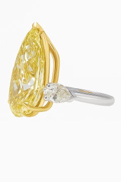 GIA Certified 3.01 Carat Fancy Intense Yellow Pear Cut Diamond Three Stone Ring
