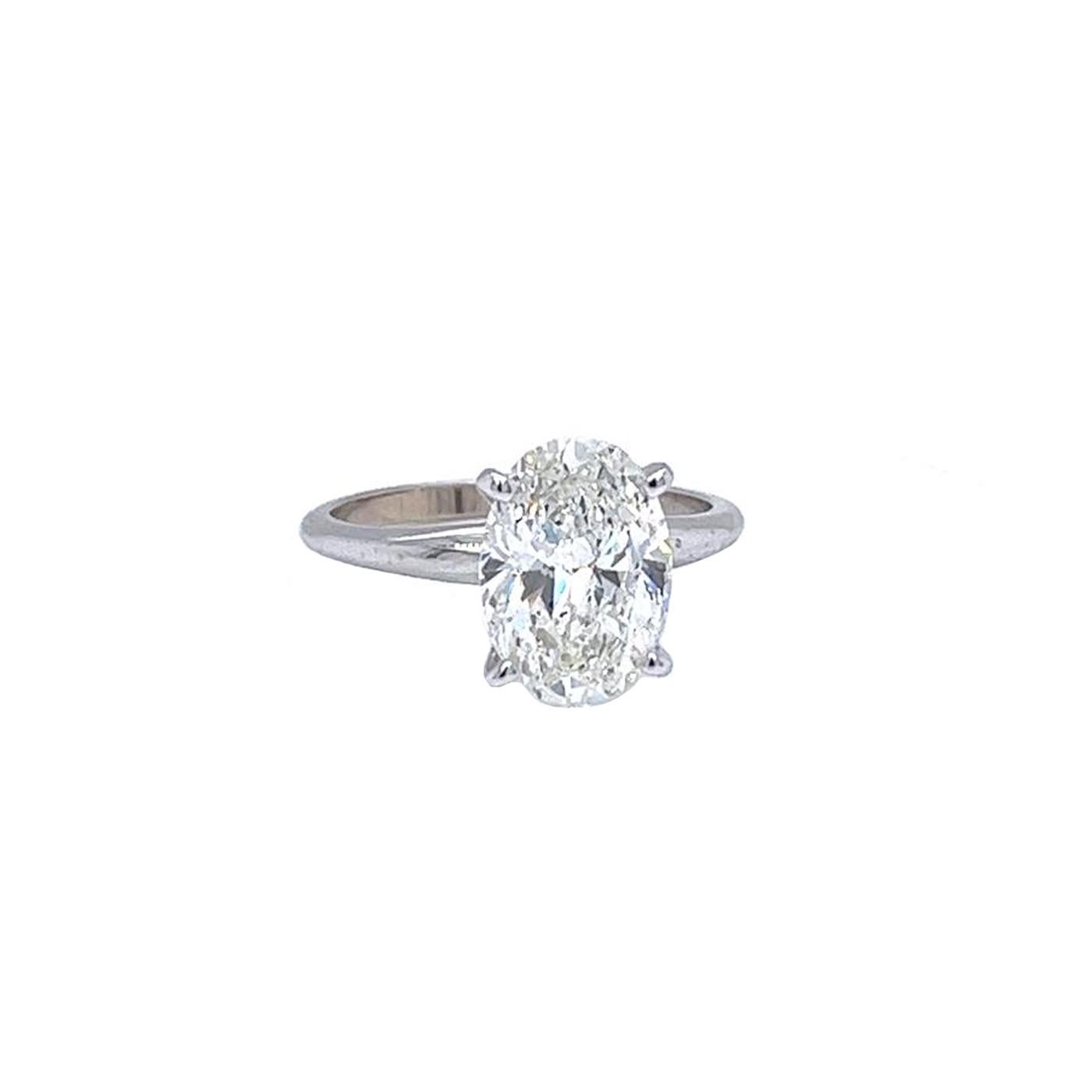 This beautiful ring features a 3.02-carat oval Brilliant Cut Diamond Tiffany Style in 14K Gold with dimensions of 11.42 x 8.22 x 4.68 mm. It has an Oval Brilliant cut with a Si1 clarity grade with I Color, GIA certified with Very Good polish, and