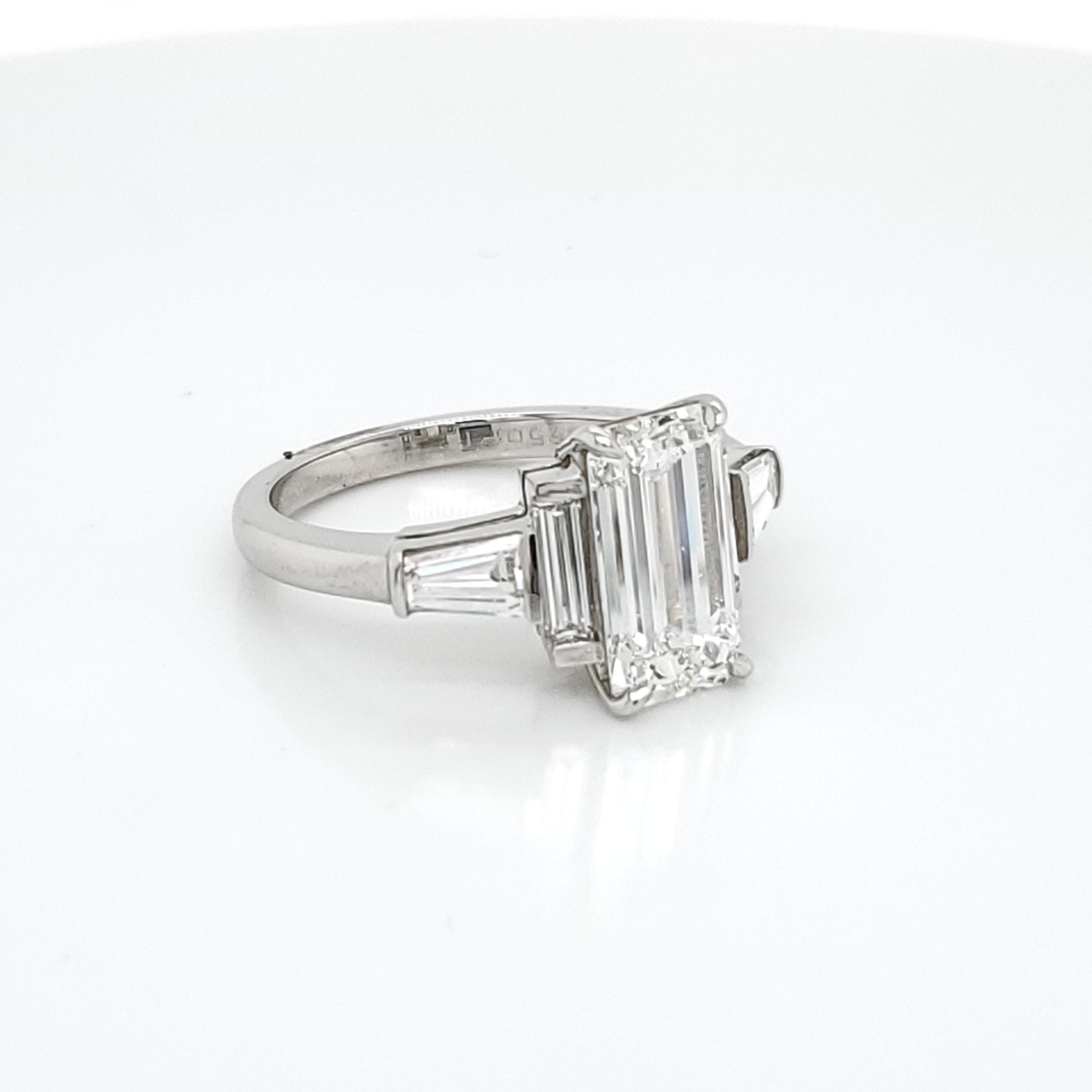 GIA Certified 3.02 Emerald Cut Diamond Five Stone Ring. The center stone is GIA certified G Color VS1 clarity. On the side of the 3.02 Emerald Cut Diamond are 2 very long shaped emerald cut diamonds followed by two  step cut tapered baguettes. The