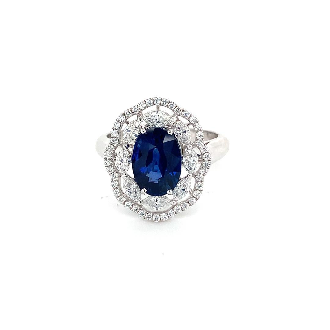 Natural GIA Certified 3.03 Carat Blue Sapphire with 0.78 Carat Diamond Ring set in 18 Kt white gold. Sapphire delightfully encompassed by two layers of halo. One of is Marquee shape and other one is round shape halo.

