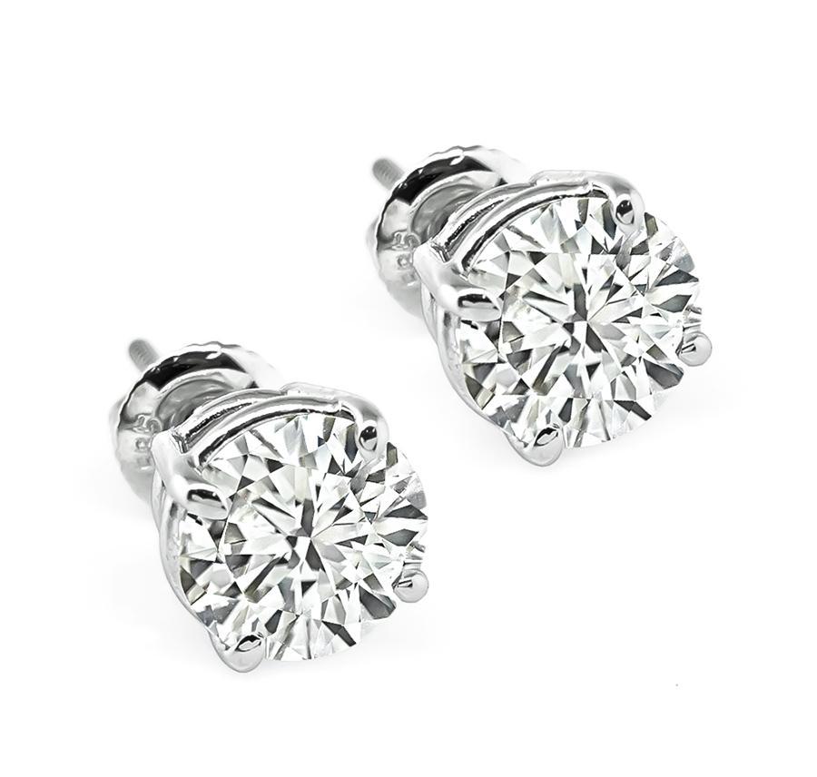 This is a gorgeous pair of diamond 14k white gold stud earrings. The earrings are set with sparkling GIA certified round cut diamonds that weigh 1.52ct and 1.51ct; the color of the diamonds is J with VS2 clarity and I with SI1 clarity respectively.