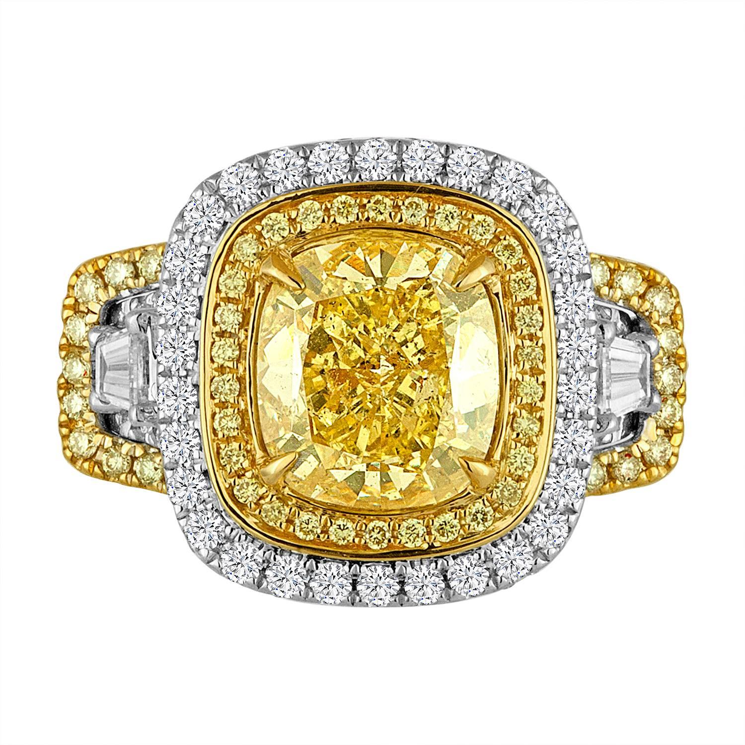 Gorgeous GIA  Certified Natural Fancy Yellow Even 3.04 Carat encircled in a double Halo of Natural Fancy Yellow Rounds 0.75 Carats Round and White Diamond Rounds 1.20 Carat Flanked by 2 White diamond Tapers 0.54 Carat in a One of a Kind very