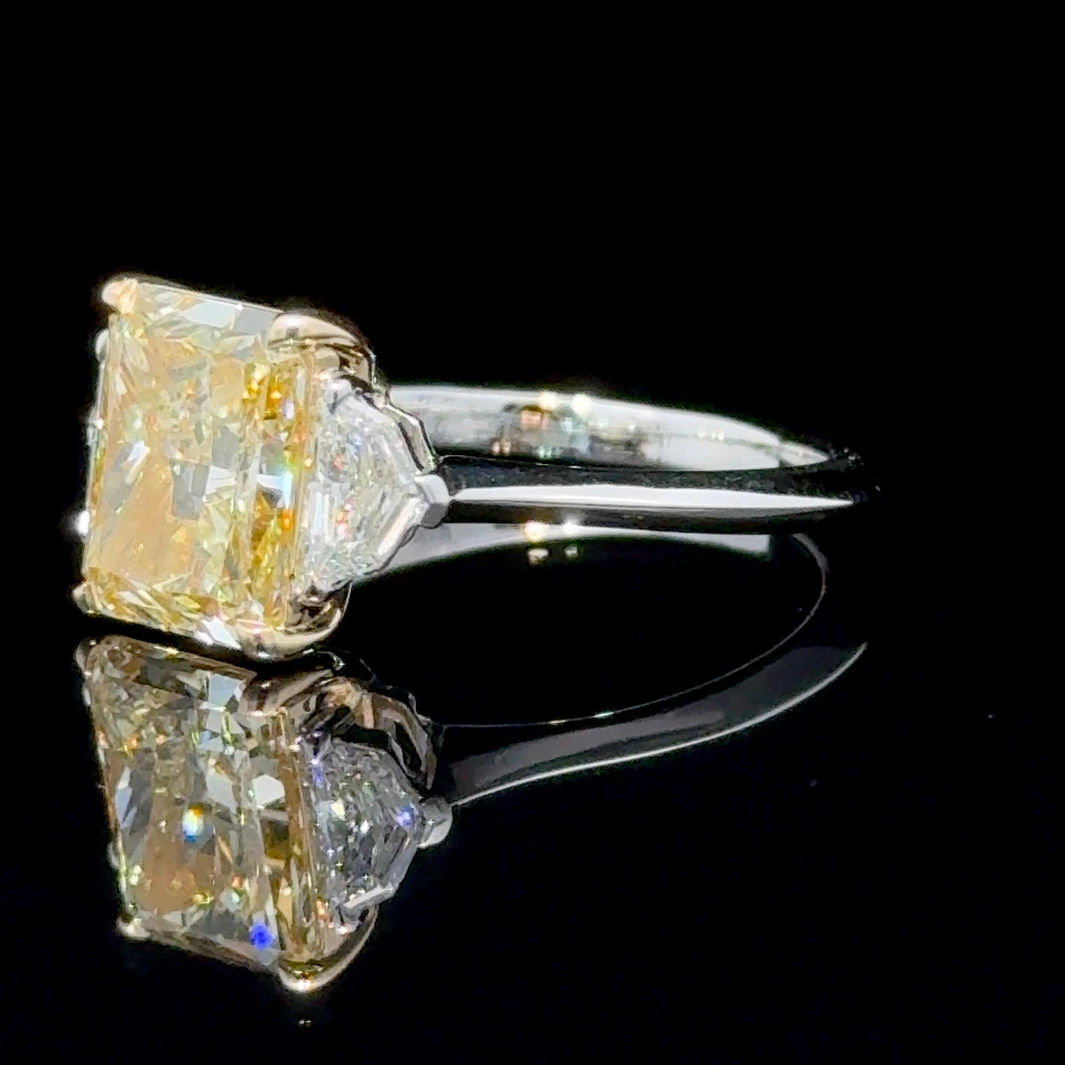 GIA Certified 3.04 Carat Radiant Cut Fancy Yellow Diamond Three Stone Ring In New Condition For Sale In New York, NY
