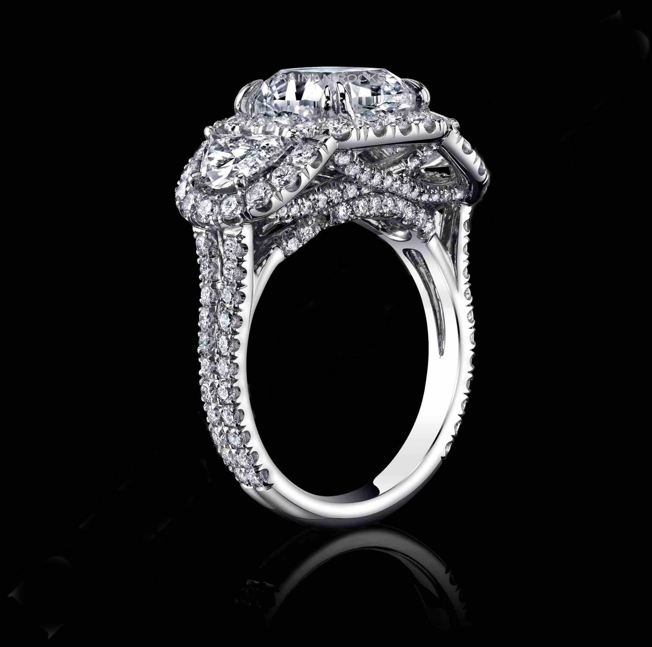 A classical 3 stone ring with 3.04ct Cushion E SI2 Natural Diamond at the center with 2 Half Moon shapes hugging the sides and nearly 100 Round natural diamonds set in platinum

This diamond is GIA certified.