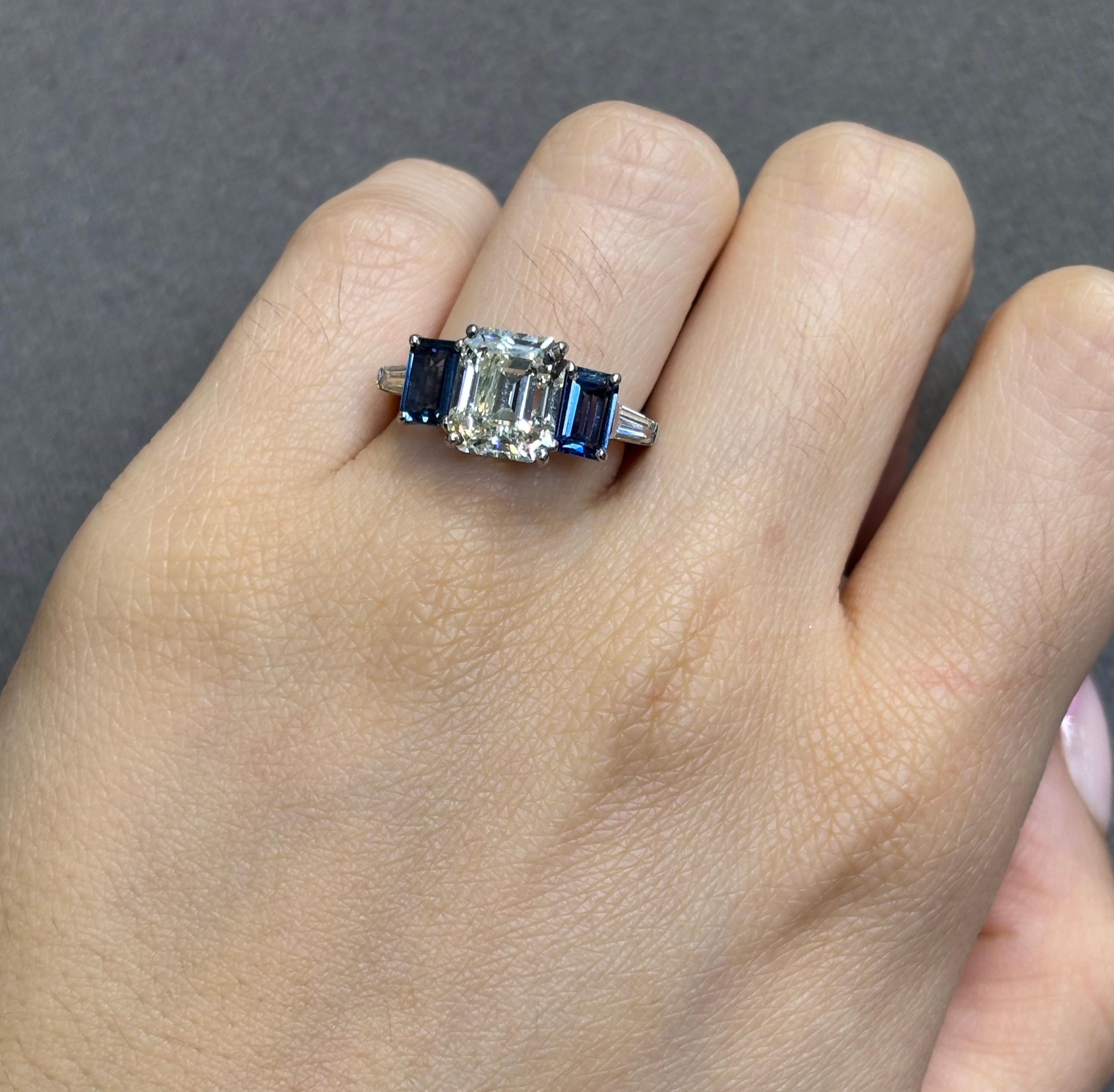 GIA Certified 3.05 Carat Emerald Cut Diamond and Sapphire Ring

A platinum ring centering a GIA-certified baguette-cut diamond, flanked by two emerald-cut sapphires and accented by a tapered baguette diamond on either side. 

Approximate Emerald Cut