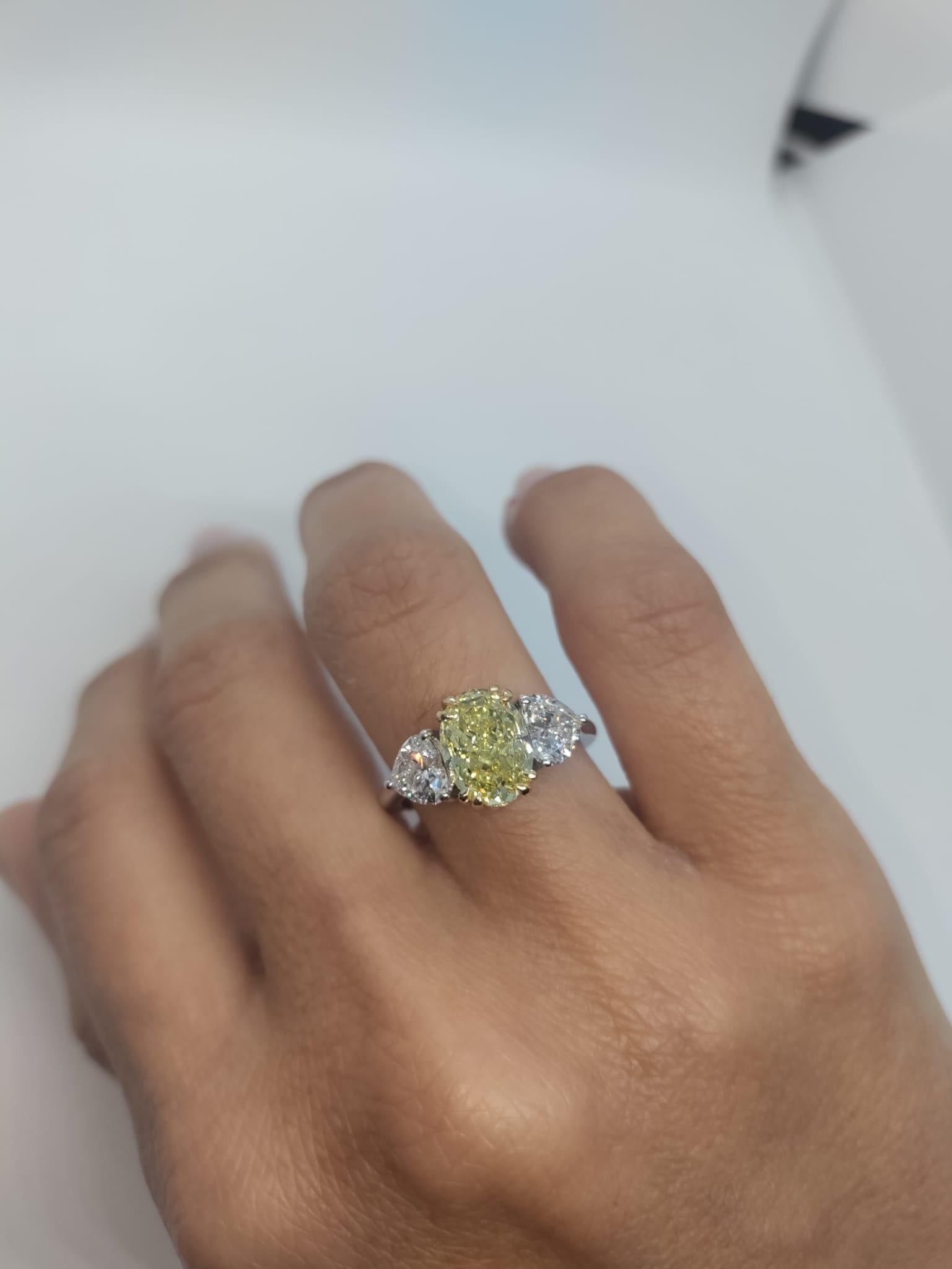 An exquisite Antinori Fine Jewels creation. A 3.05 carat fancy yellow oval diamond solitaire with an extremely bright and even fancy yellow color.

The side diamonds are internally flawless d color triple excellent none fluorescence investment grade