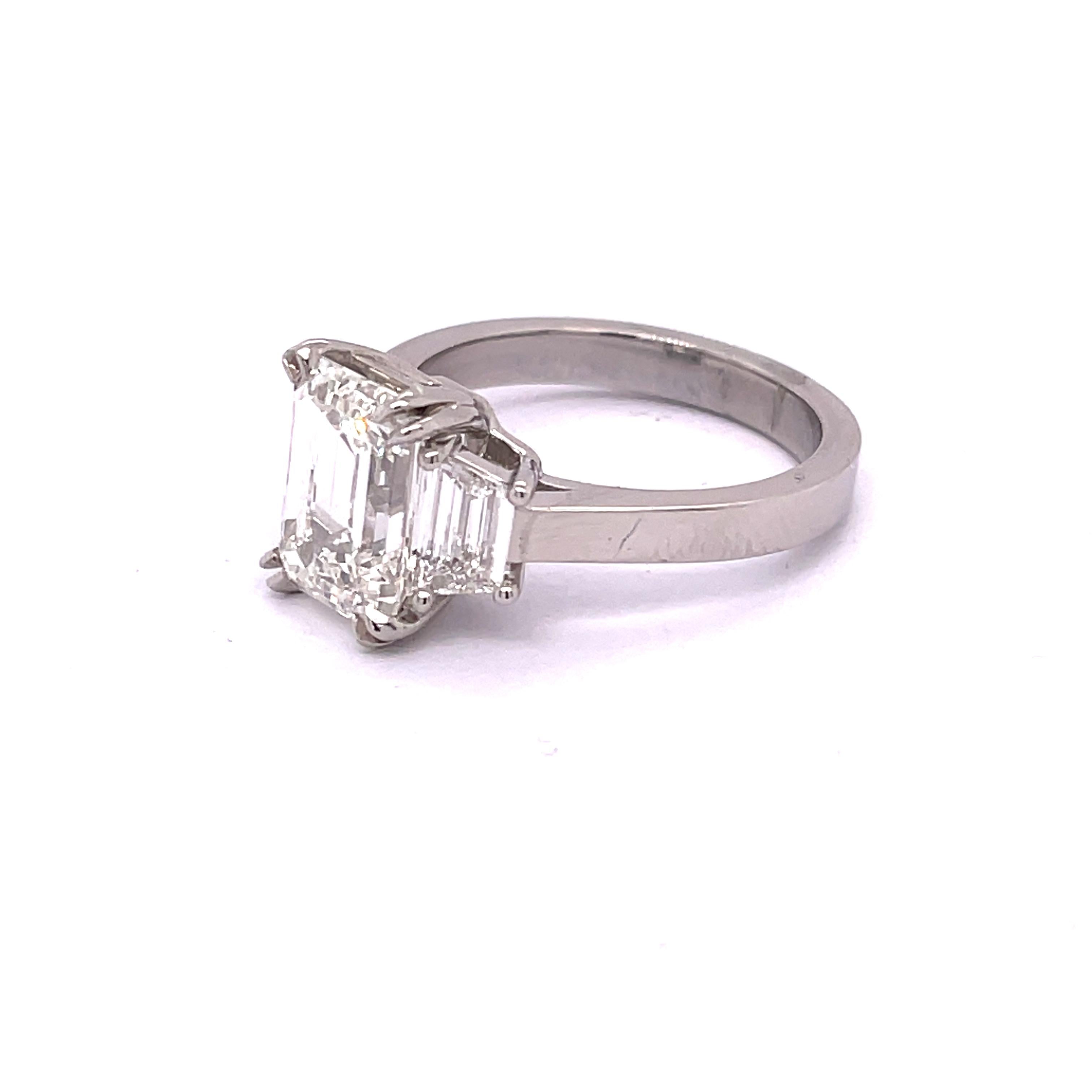 Dazzling GIA Certified 3.05 Emerald Cut Engagement Ring 

Setting:
Platinum

Center Stone: 
Emerald Cut Diamond 3.05ct
Clarity: VS1
Color: H

Side Stones: 
Clarity: VS
Cut: Excellent
The total approximate weight of side stones: 0.65ctw

•Free