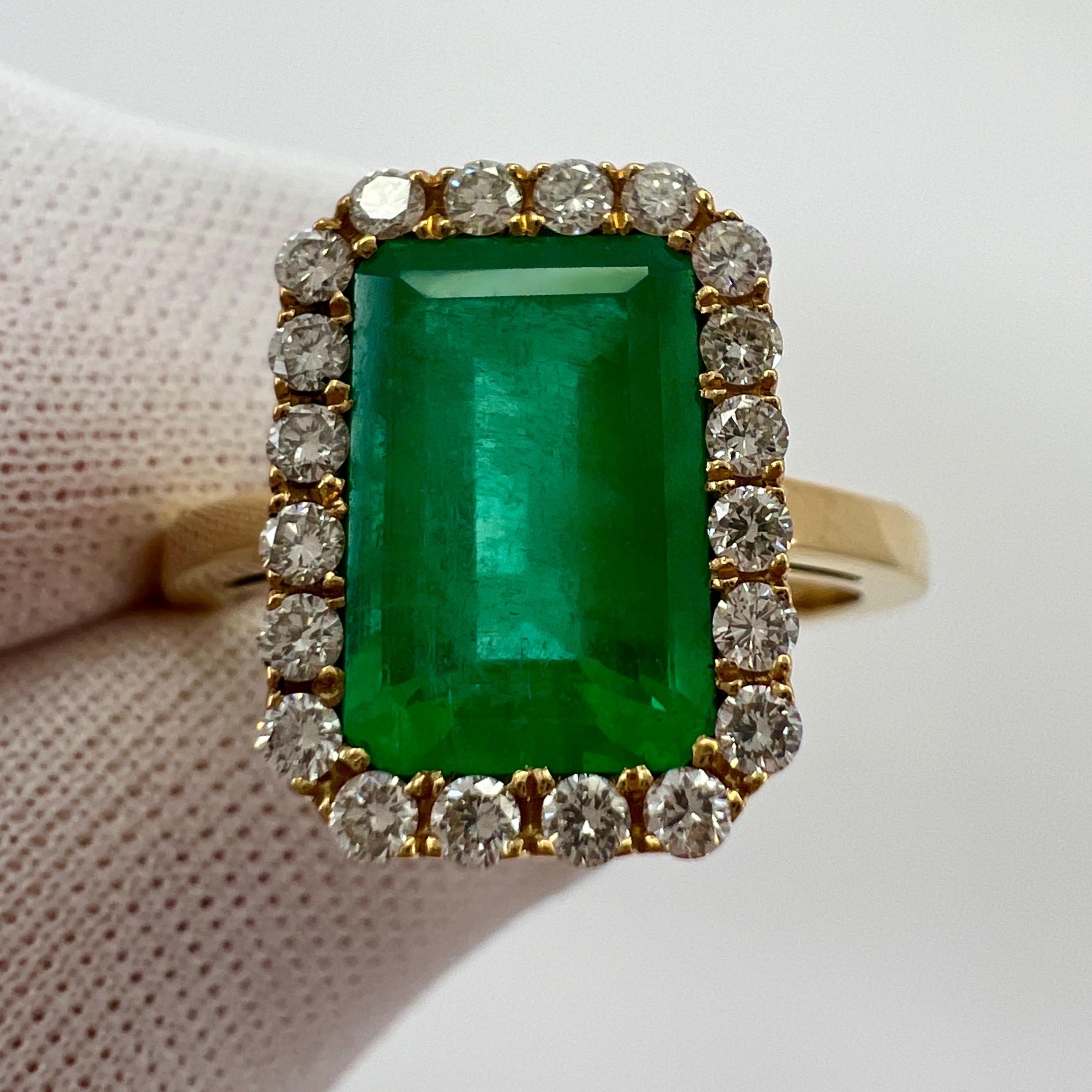 Fine GIA Certified Vivid Green Colombian Emerald & Diamond 18k Yellow Gold Halo Ring. 3.06 Total Carat Weight.

Large 2.72 carat emerald with a stunning intense vivid green colour and very good clarity.

This stone has some small natural inclusions