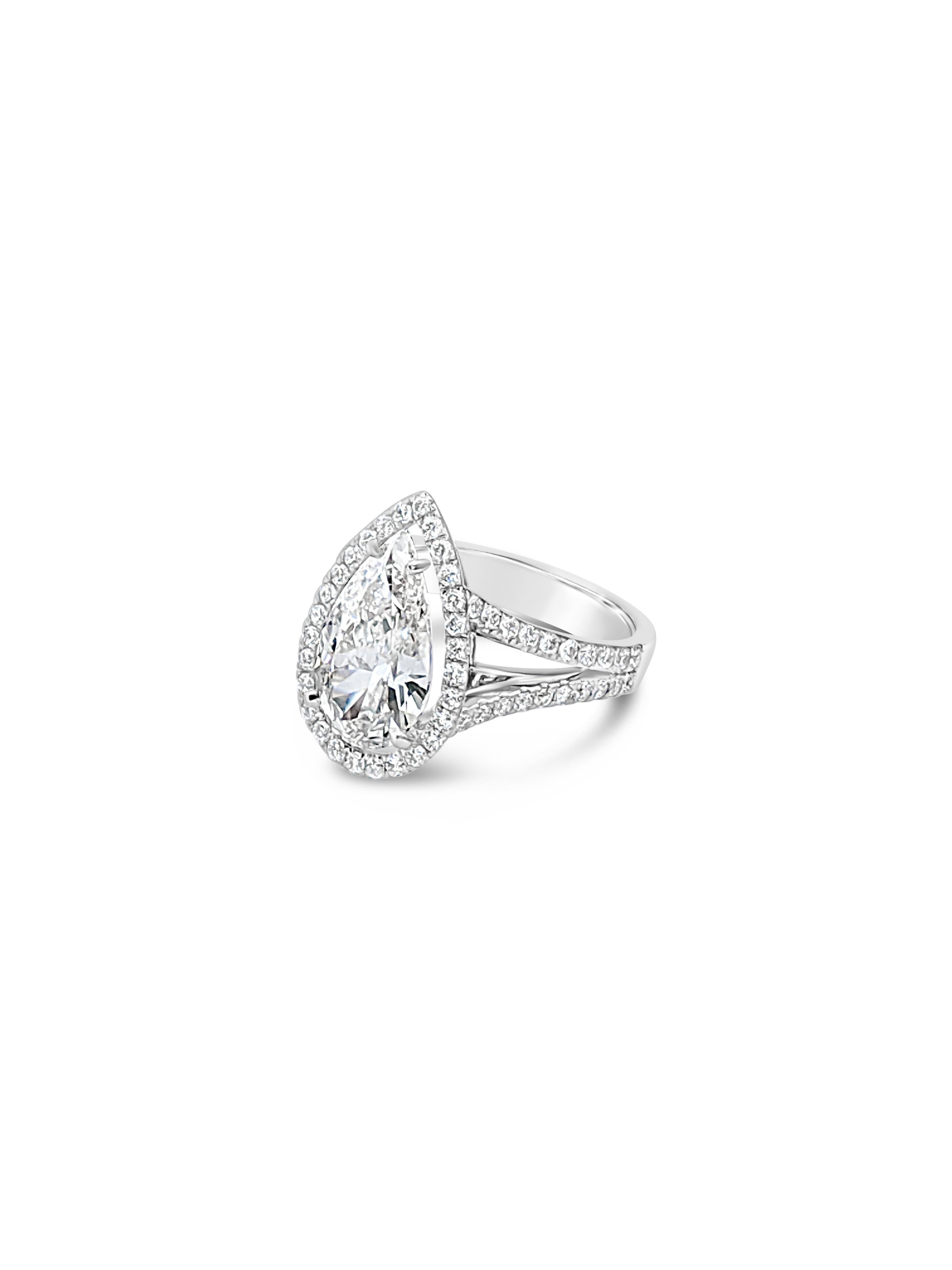 A stunning 3 carat pear shape diamond is set delicately in a halo of super fine white diamonds that is balanced on a perfect split shank of pave set diamonds.   Combining a classic glamorous diamond cut with a modern setting creates an unique work