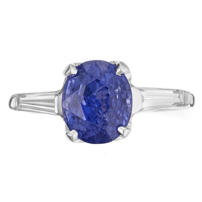1950's Three-stone sapphire and diamond engagement ring. GIA certified natural untreated oval sapphire center stone with 2 tapered baguette side diamonds in a three-stone platinum setting. This sapphire graded by the GIA as natural, not heat color