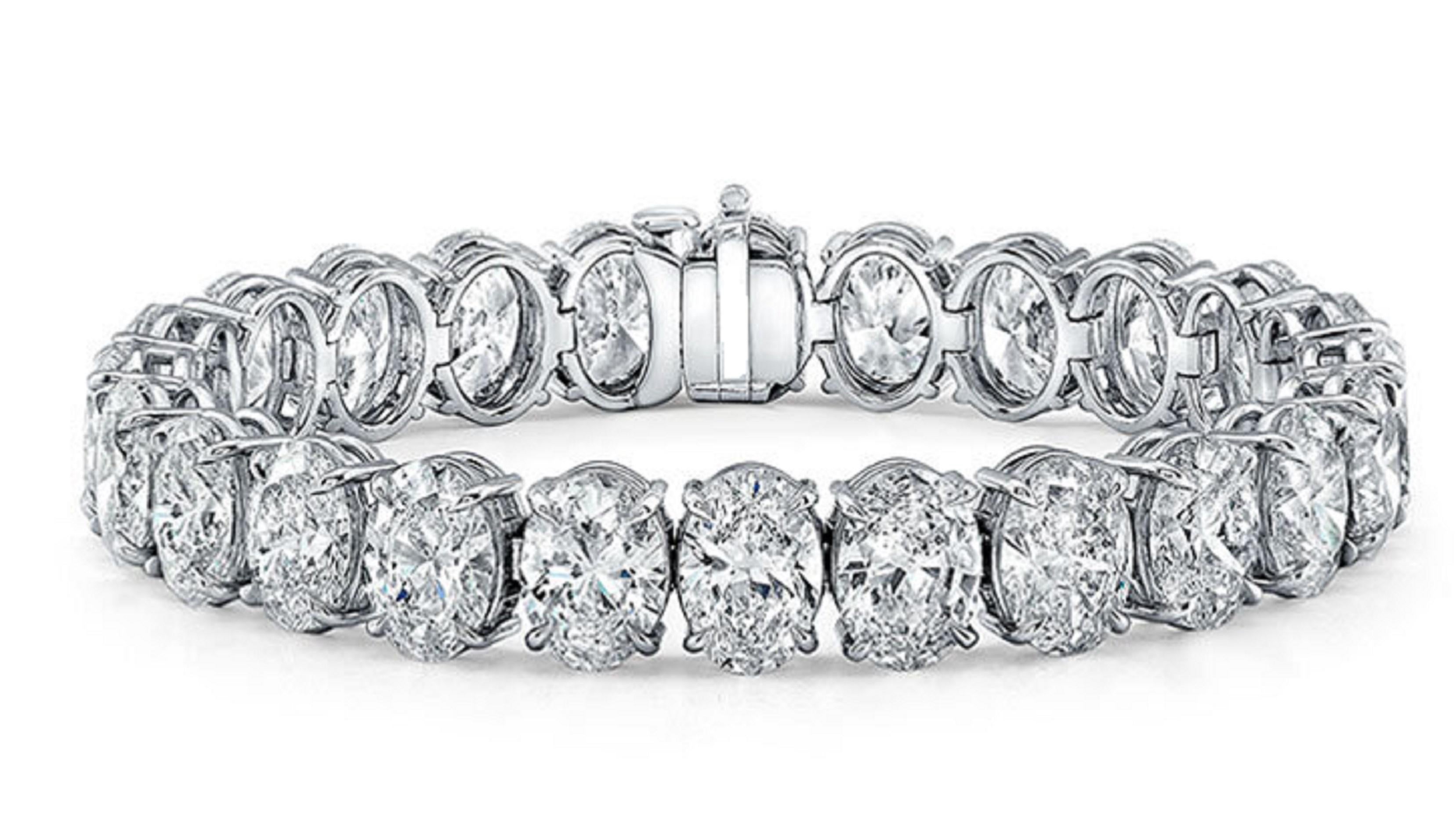 Indulge in the epitome of elegance and luxury with our stunning 7' Tennis Bracelet, meticulously crafted in platinum and adorned with 31 mesmerizing oval diamonds. Each diamond, certified by GIA, boasts impeccable D-F color grades and VVS2-VS2