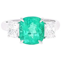 GIA Certified, 3.10 Carat Cushion Cut Emerald and Diamond Three-Stone Ring