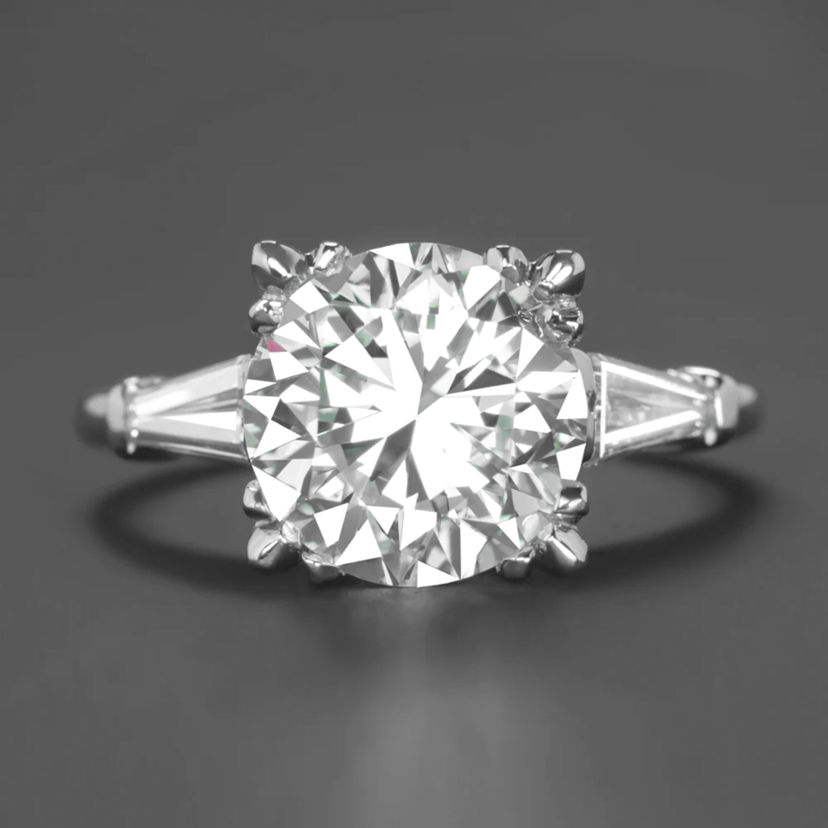 This stunning Art Deco style engagement ring features a mesmerizing 3 carat round cut diamond, GIA certified for its exceptional quality. 

With a H color grade, the diamond exhibits a near-colorless brilliance, offering remarkable radiance and