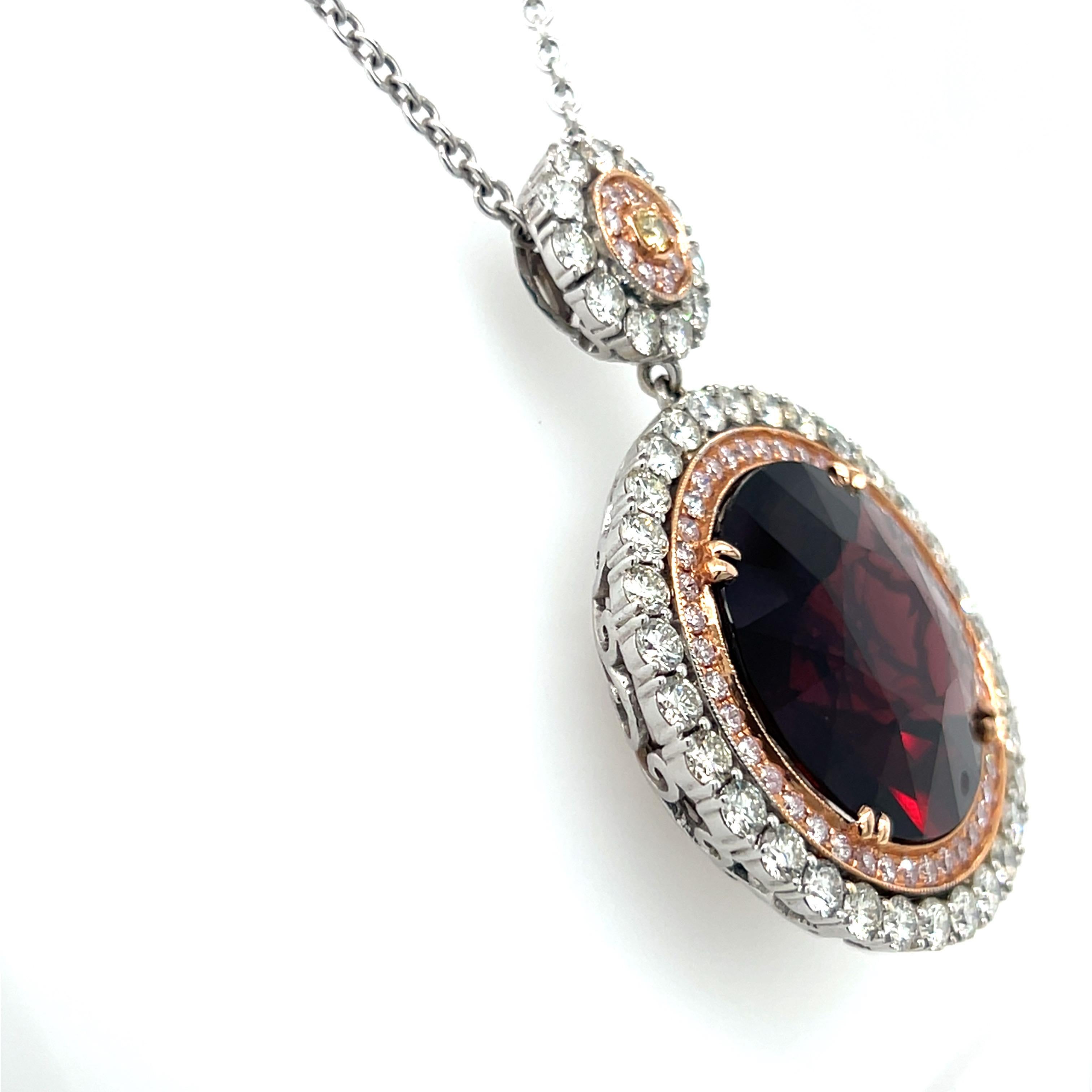 This astonishingly large GIA certified round-cut 31.02 carat red spinel pendant is surrounded by a halo of pink and white diamonds. The total carat weight of the pink diamonds is 0.83 carats, while the white diamonds total 3.36 carats. The rare size